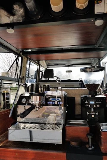 Espresso machine and coffee grinder in the back of a Land Rover 110 Defender