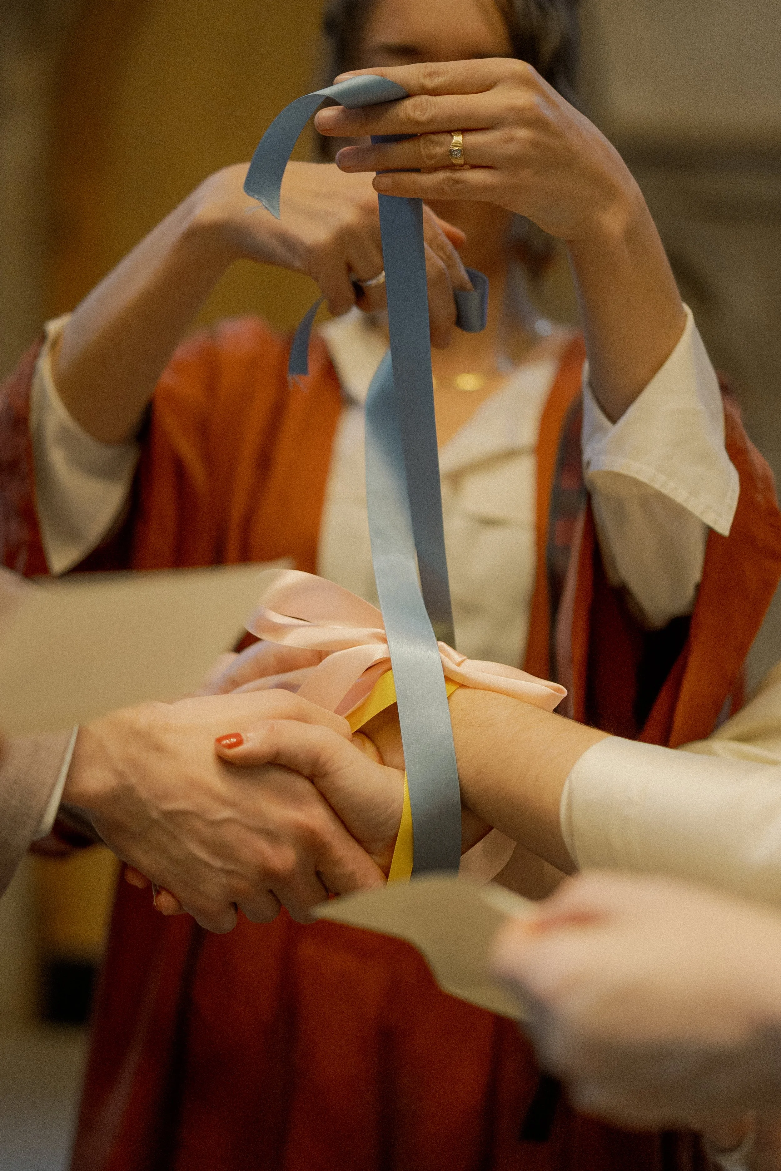 Two women holding a ribbon and cutting a ribbon together at a ceremony or celebration.