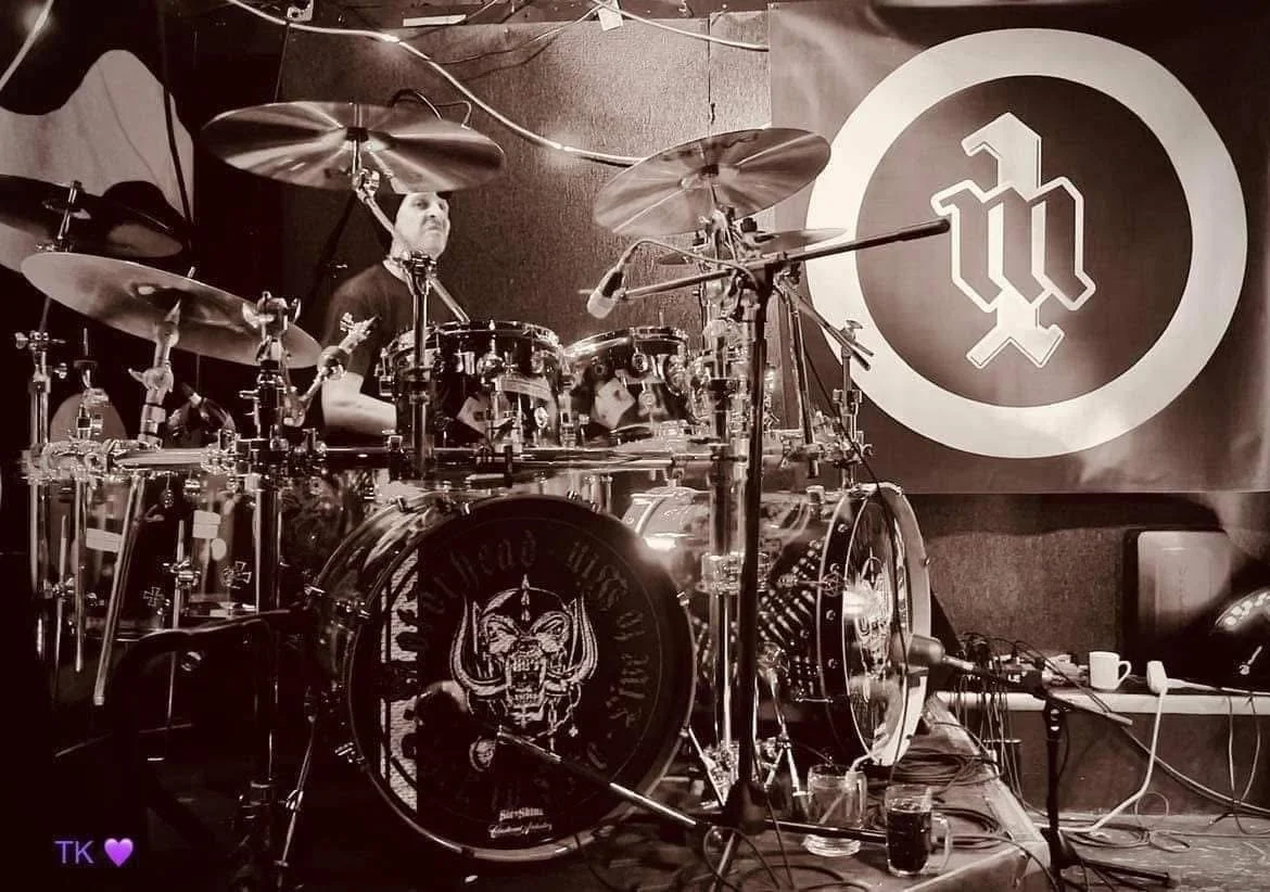 M1 Motörhead Tribute live drum kit on stage during high-energy rock performance in Canada