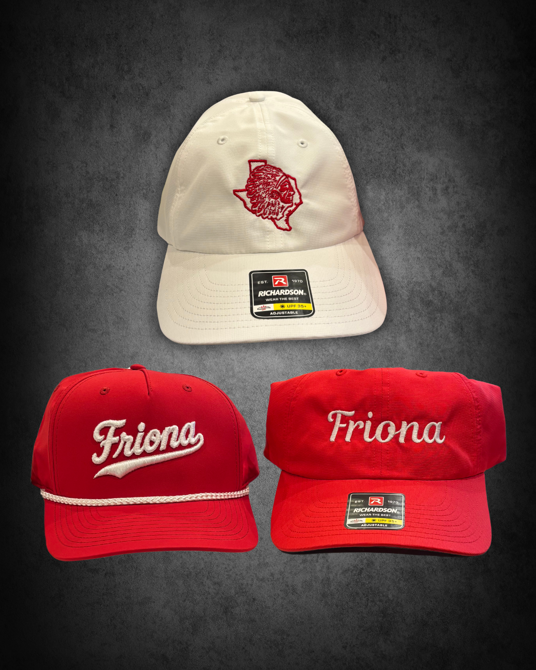 A white baseball cap with an embroidered design of a lion's head and a surrounding shape, placed on a black surface, along with two red caps embroidered with the word 'Friona' in white, and a third red cap with a Richardson brand tag.