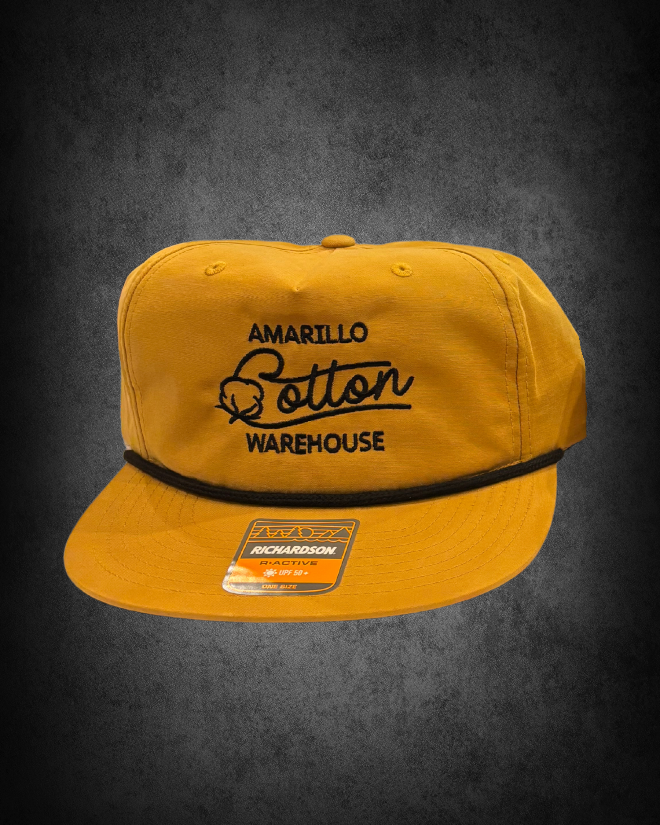 Yellow Richardson trucker cap with black embroidered text reading 'Amarillo Potter Warehouse' on the front, placed on a dark surface, with a sticker indicating UPF 50+ sun protection.