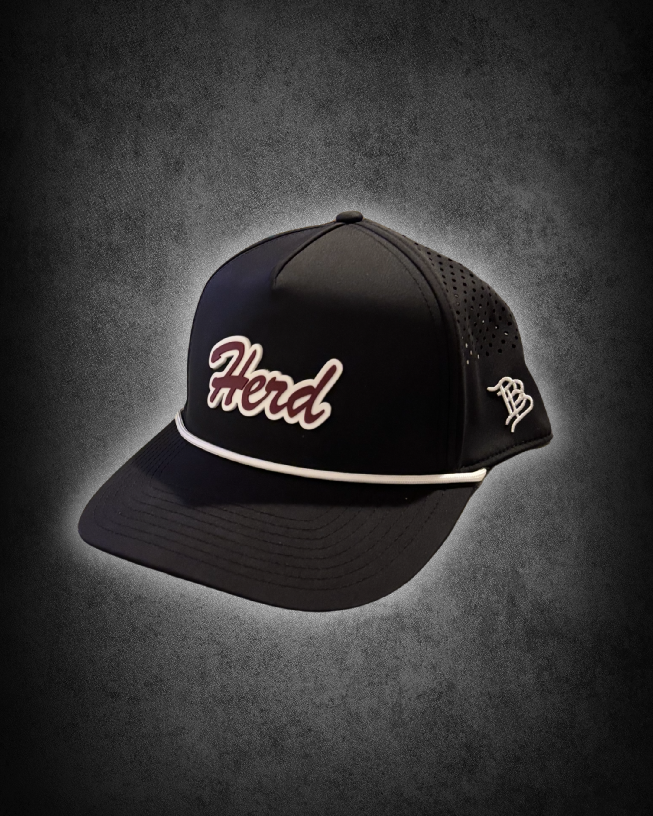 Black and white trucker cap with embroidered 'Hend' logo on front, white piping on brim, and white embroidery on side, placed on a dark surface with spotlight effect.