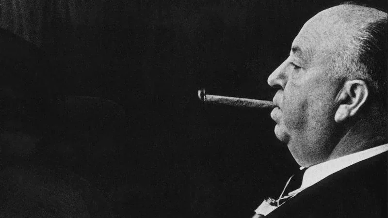 Alfred_Hitchcock_smoking_a_cigar_EGM_Cigars.webp