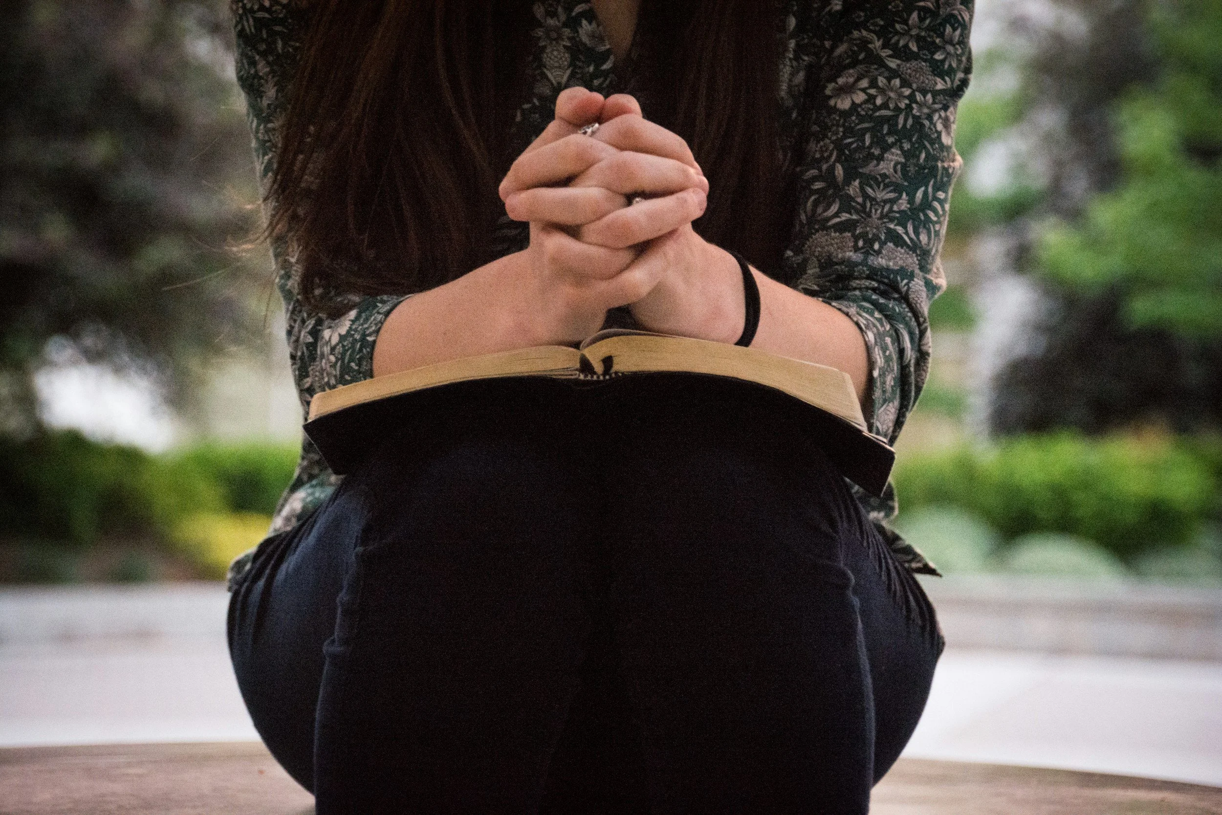 woman praying over the bible