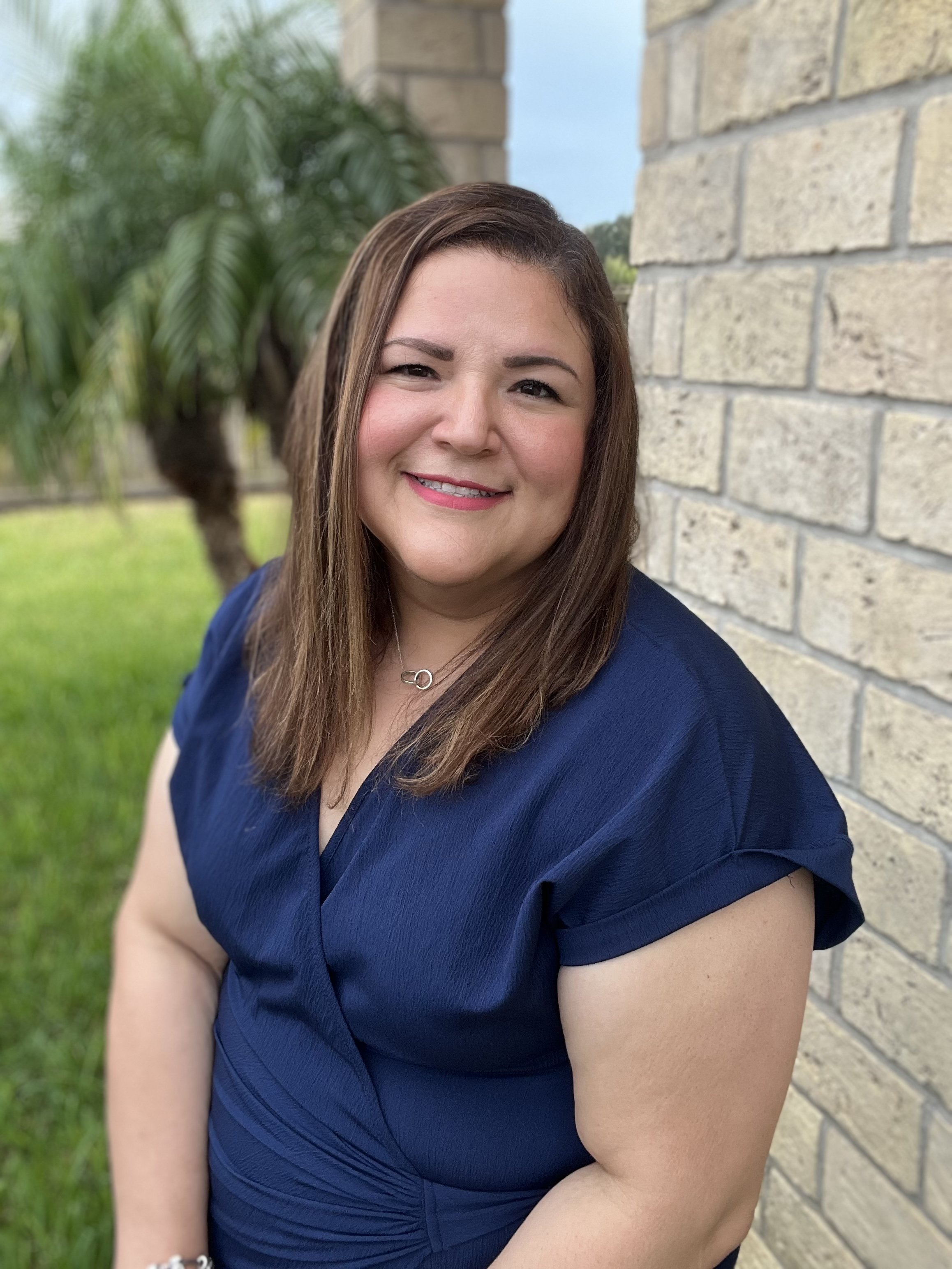 woman smiling wearing a blue shirt