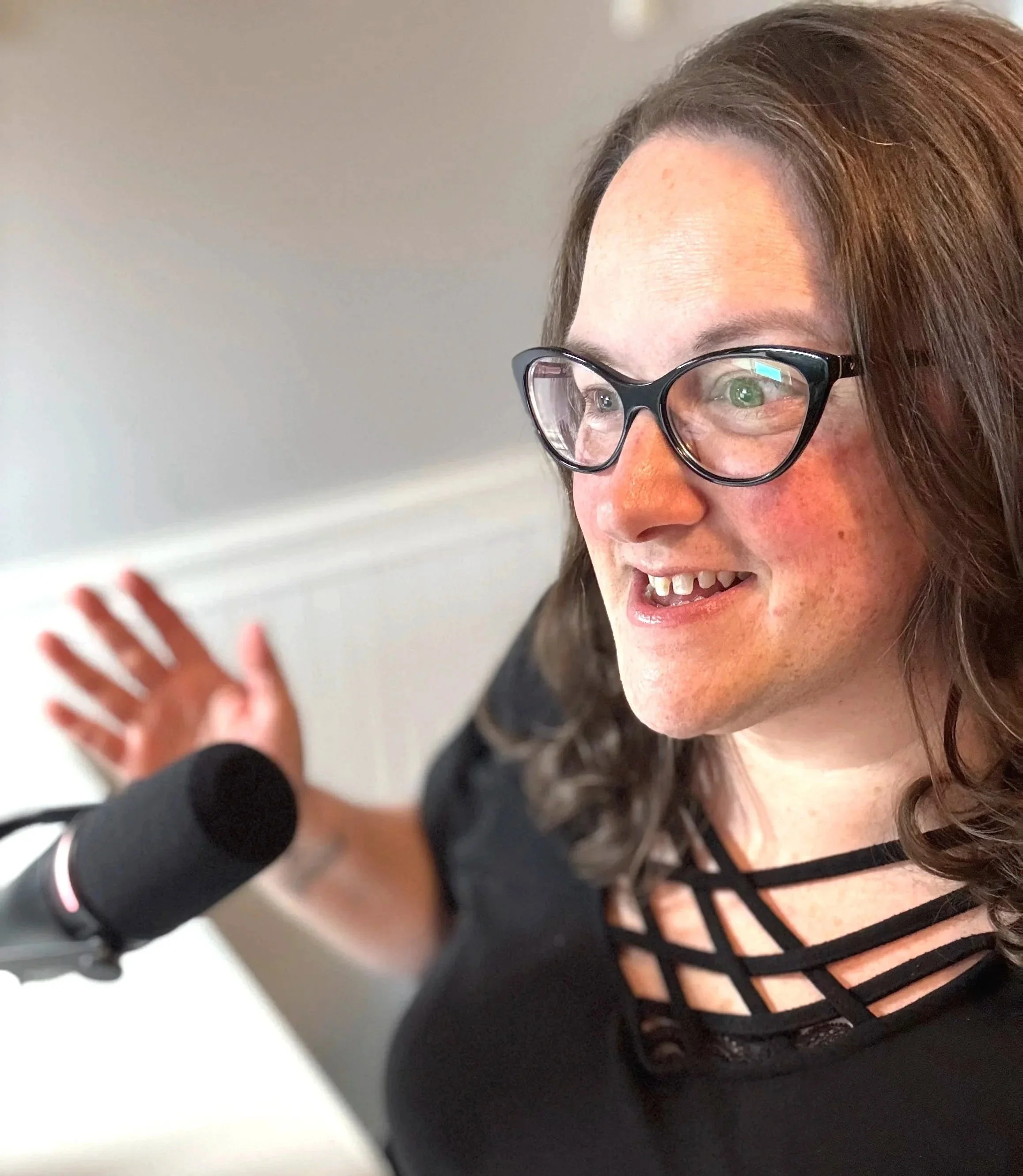 Shonda talking into a mic during coaching session