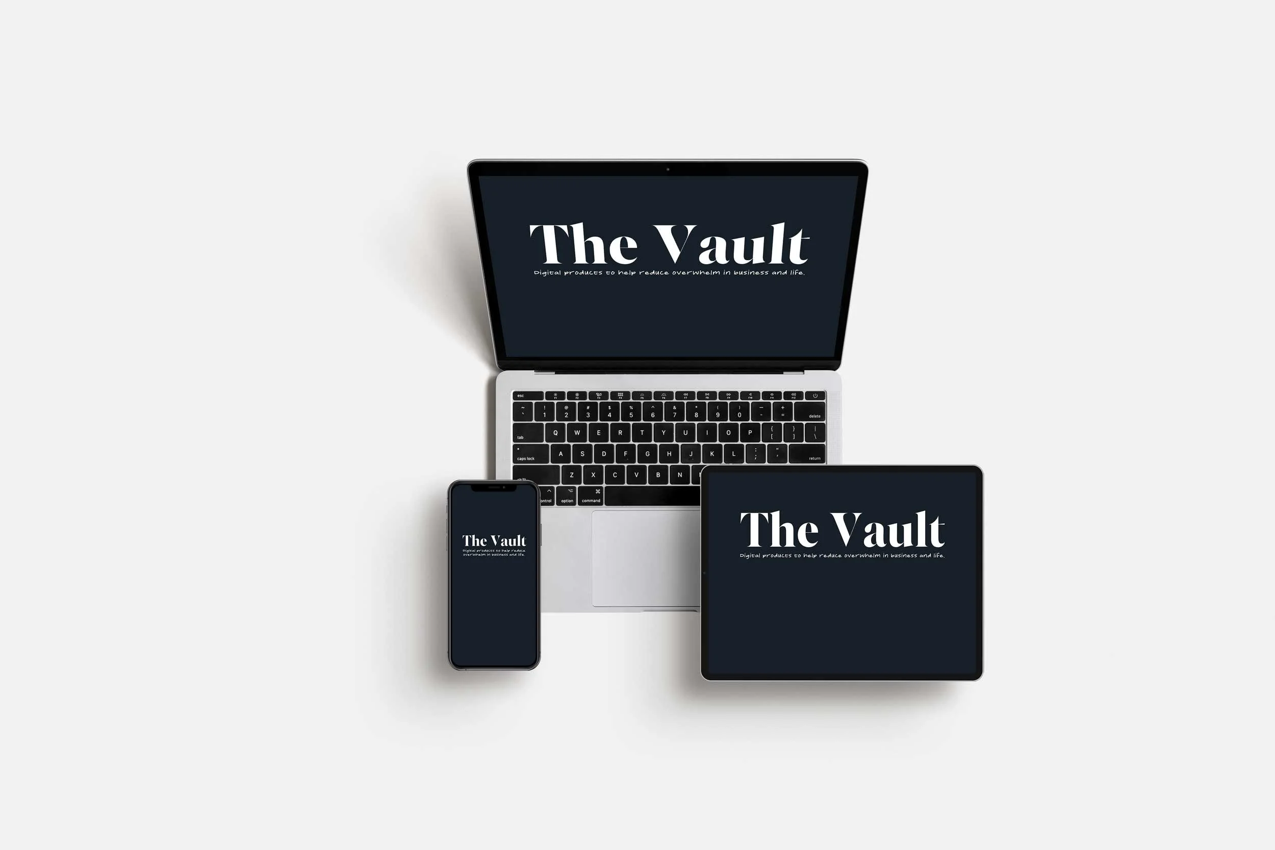 laptop, iphone, and ipad all with the words The Vault on them
