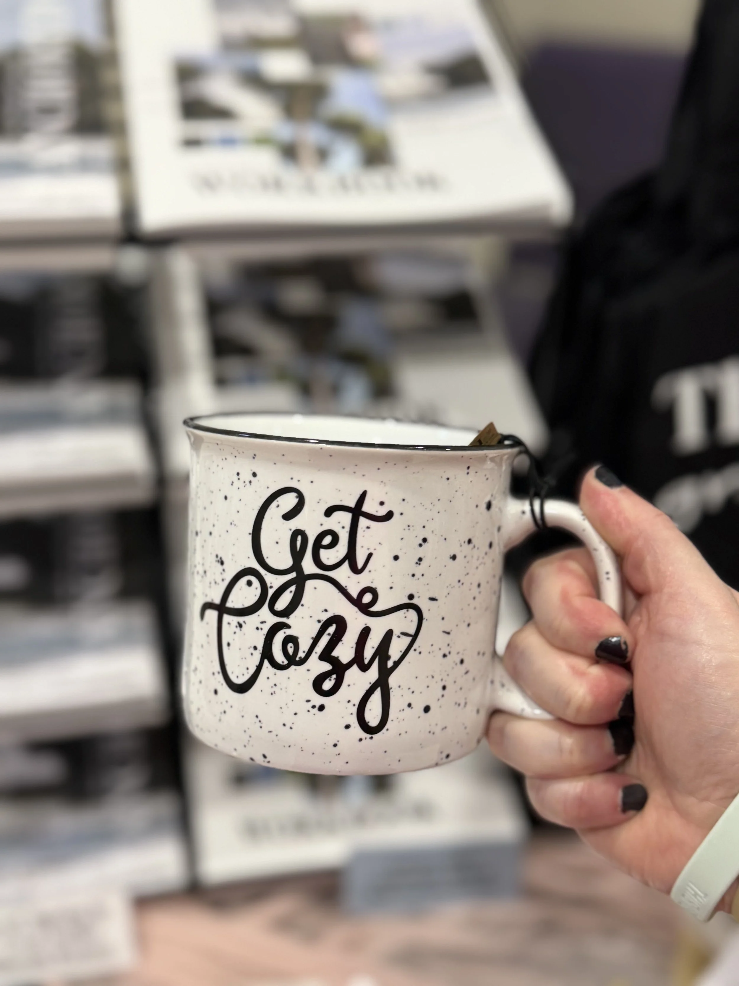 hand holding a mug that reads get cozy