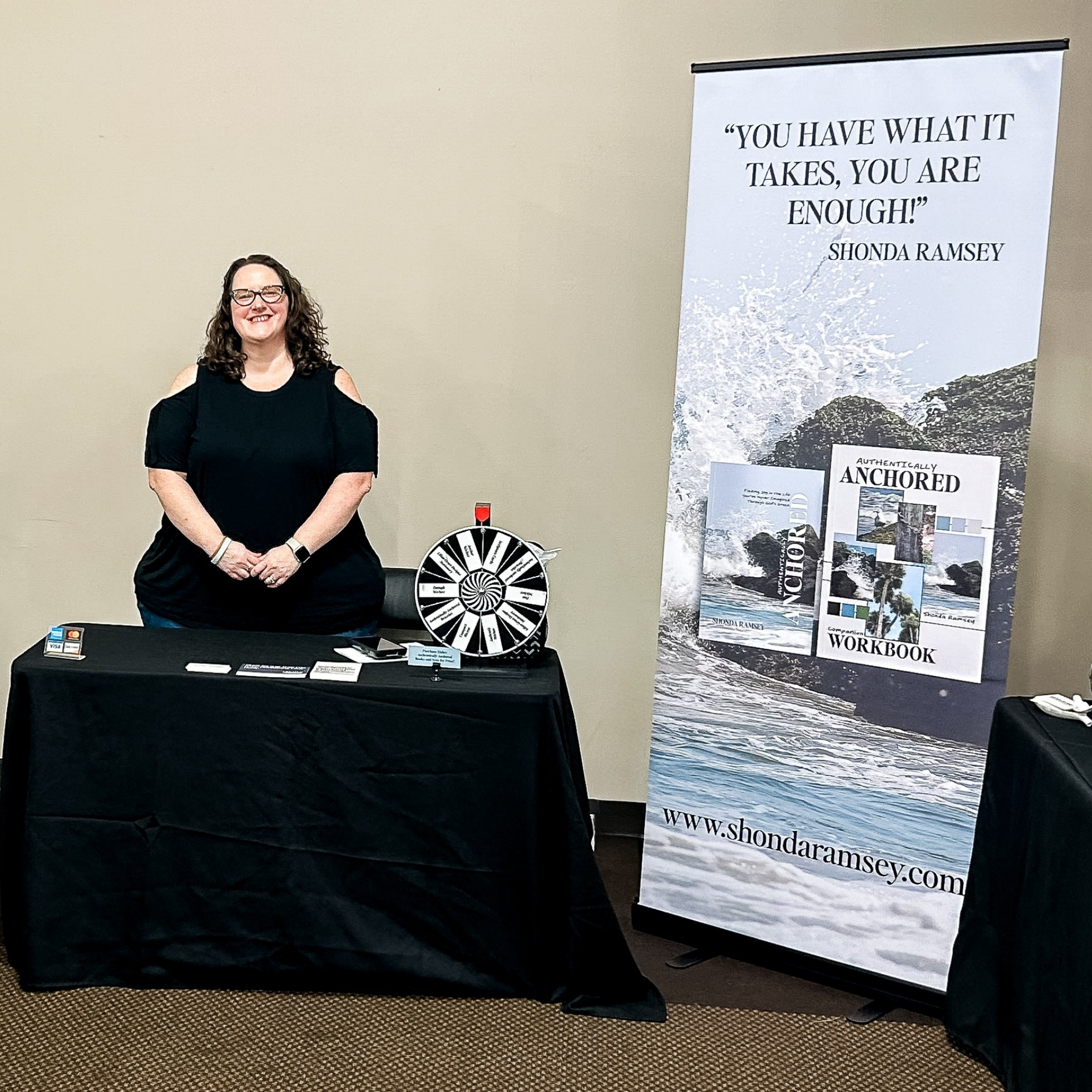 Shonda standing behind her table