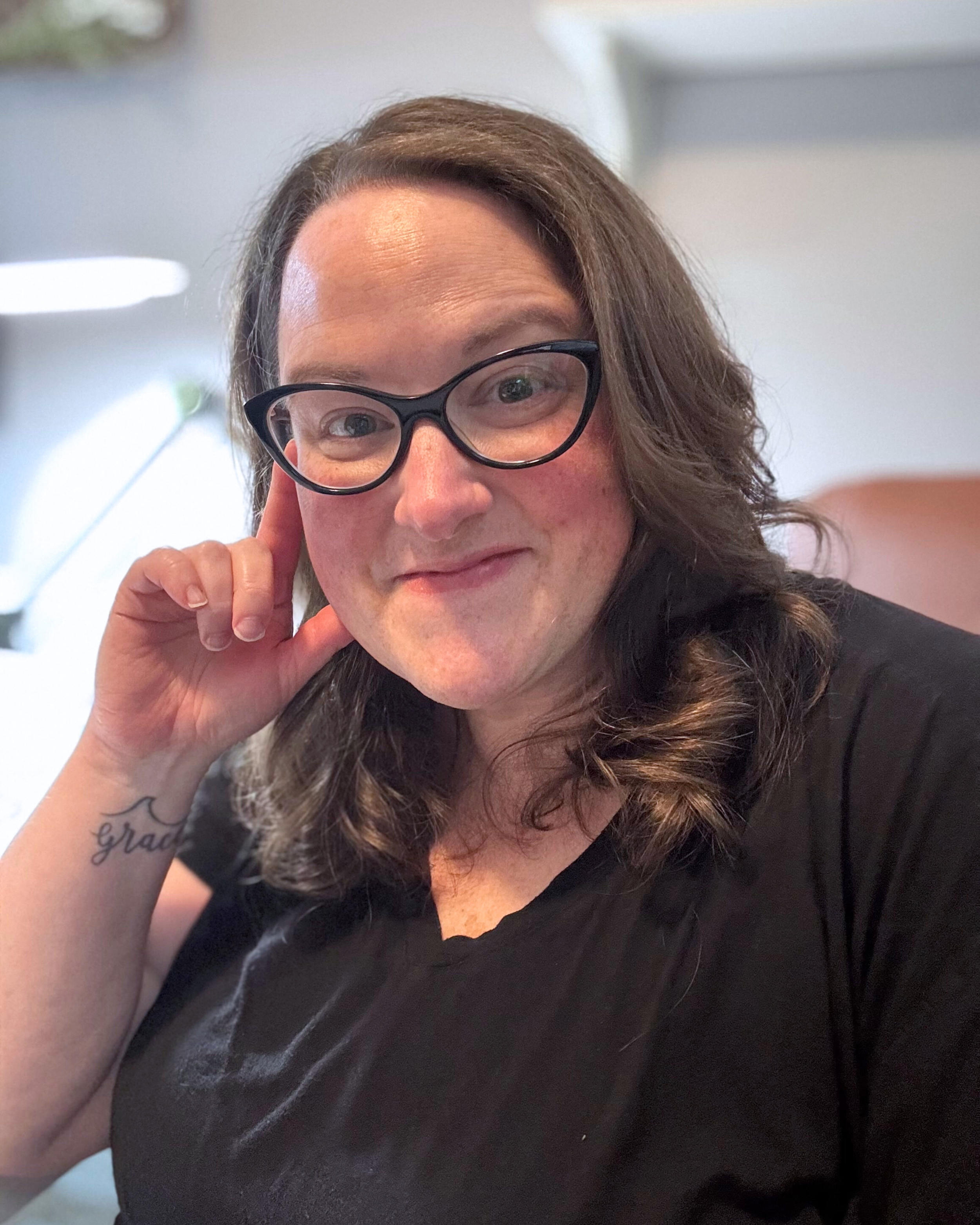 woman with hand on face smiling