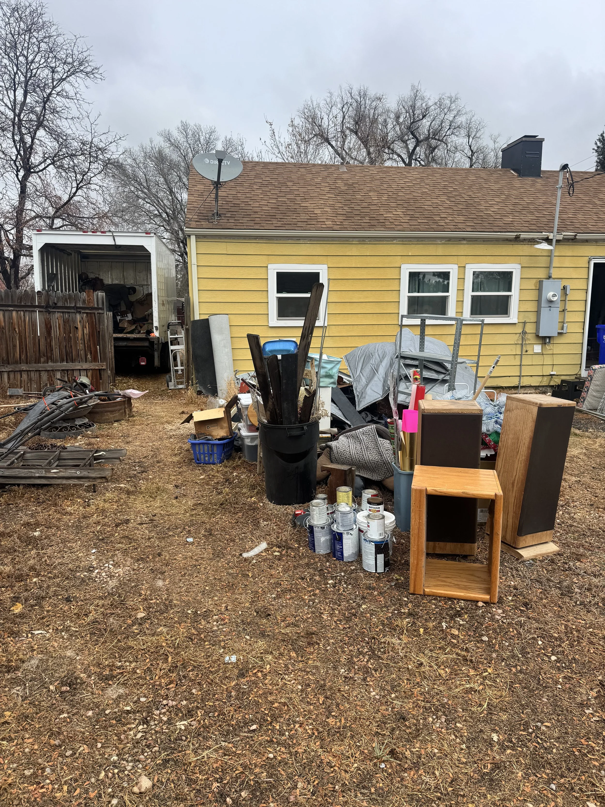 Property in Greeley Colorado before cleanout showing accumulated items and debris prior to professional removal service.