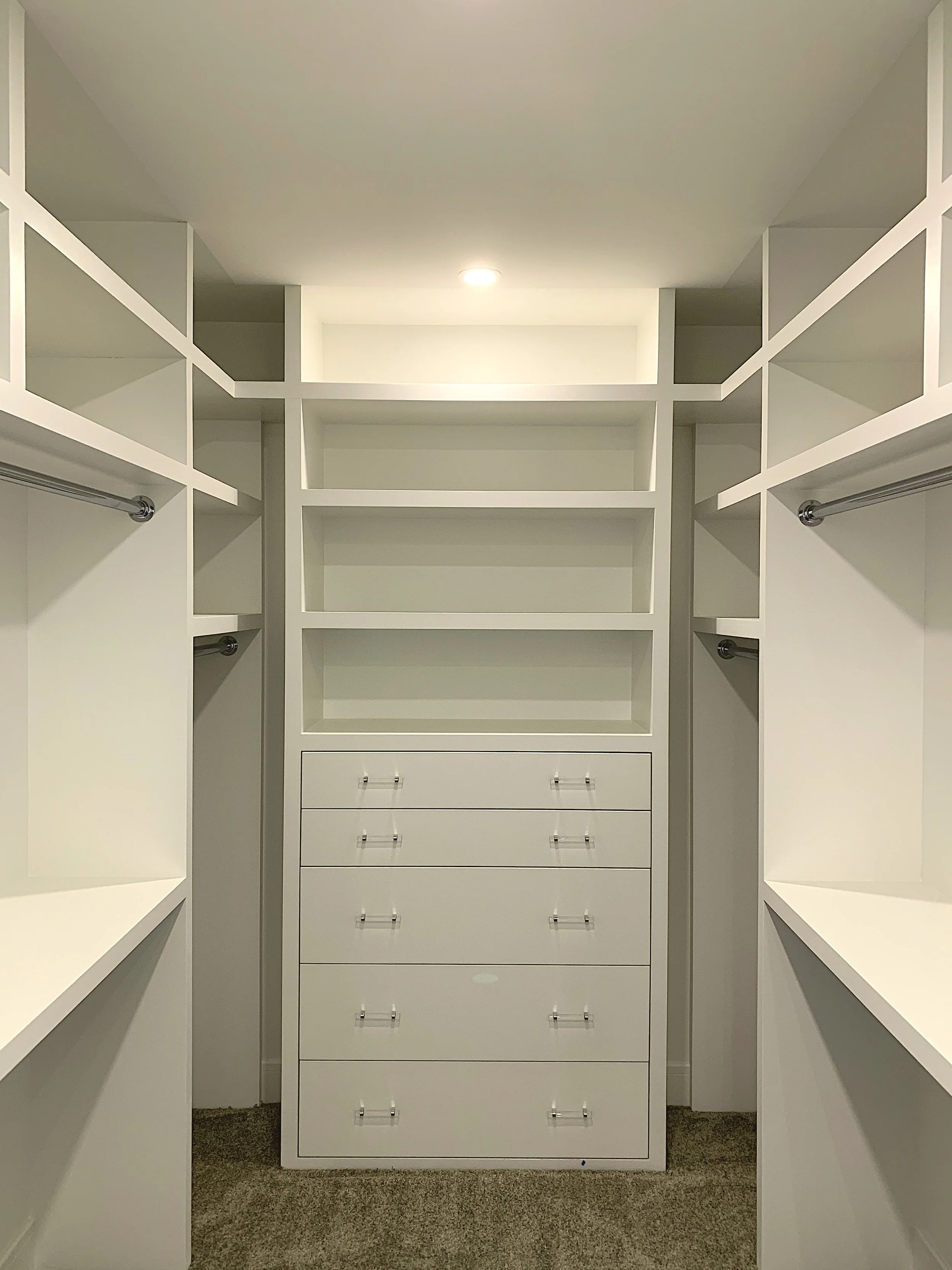 A walkin closet with painted shelves and drawers