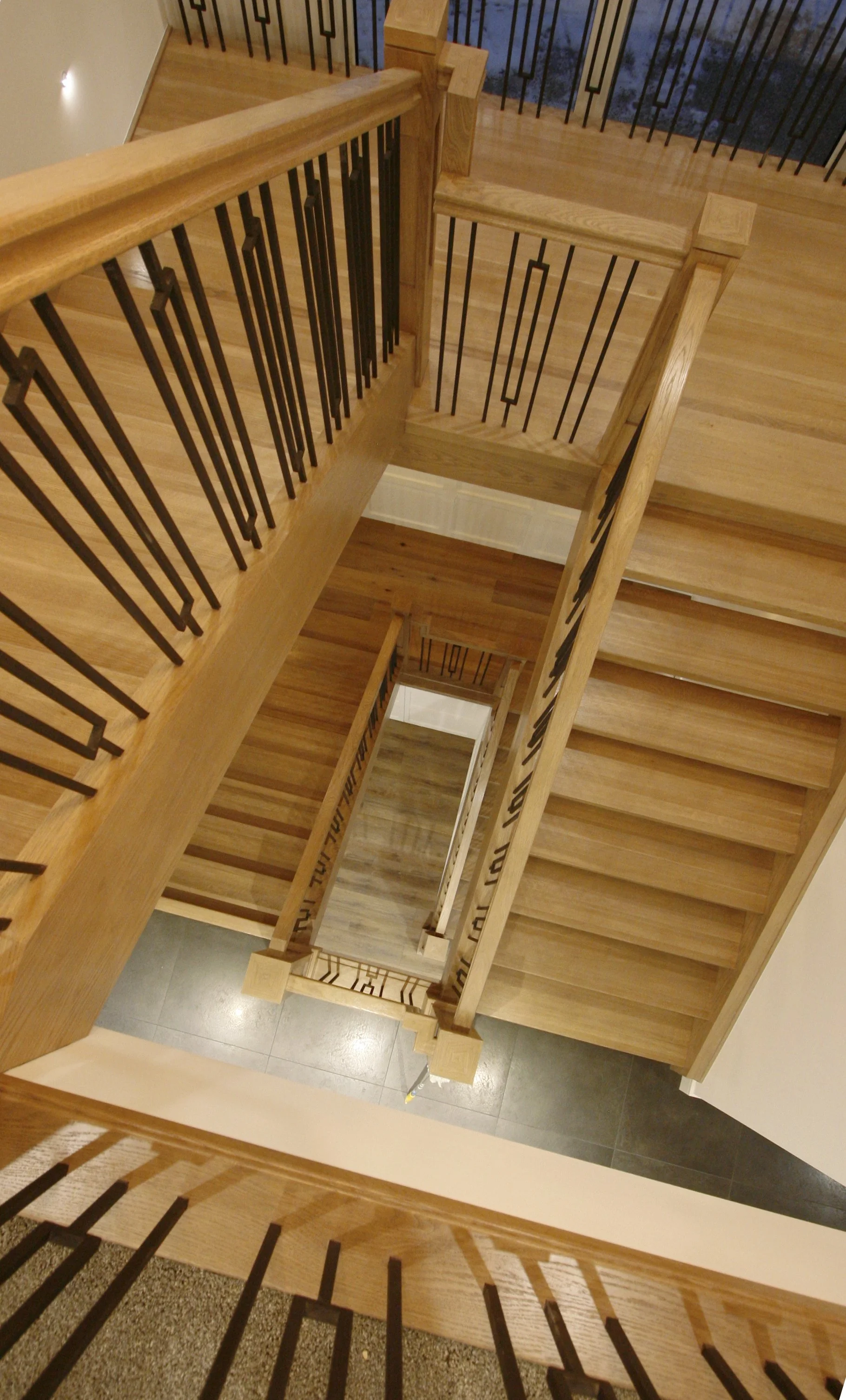 A white oak, stain staircase white wood rails