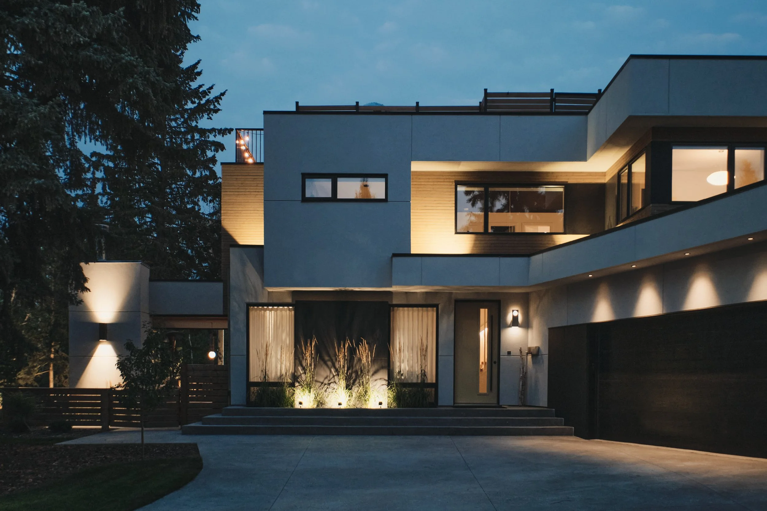 Modern architecture blending wood, concrete, and glass with warm lighting and clean geometric lines.