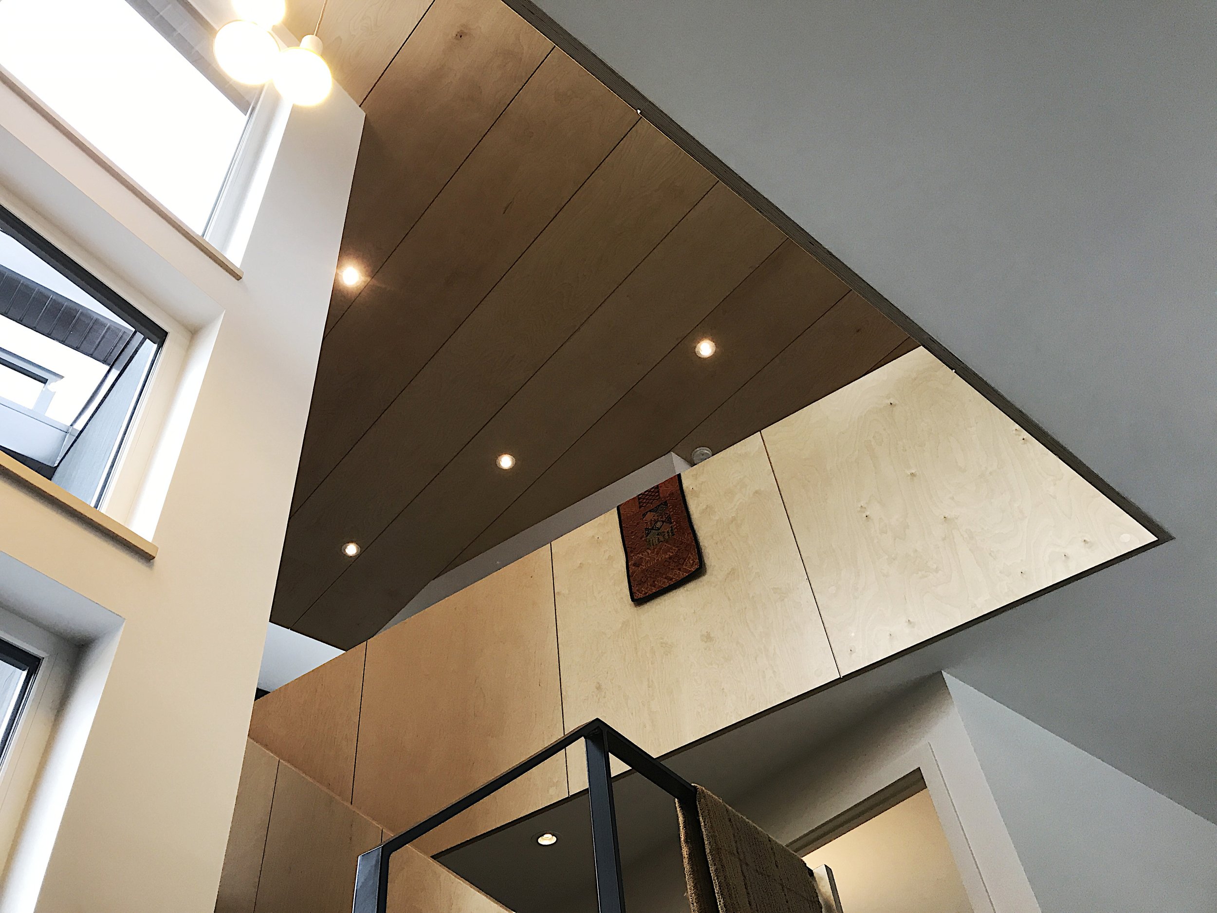 A plywood railing with a birch ceiling