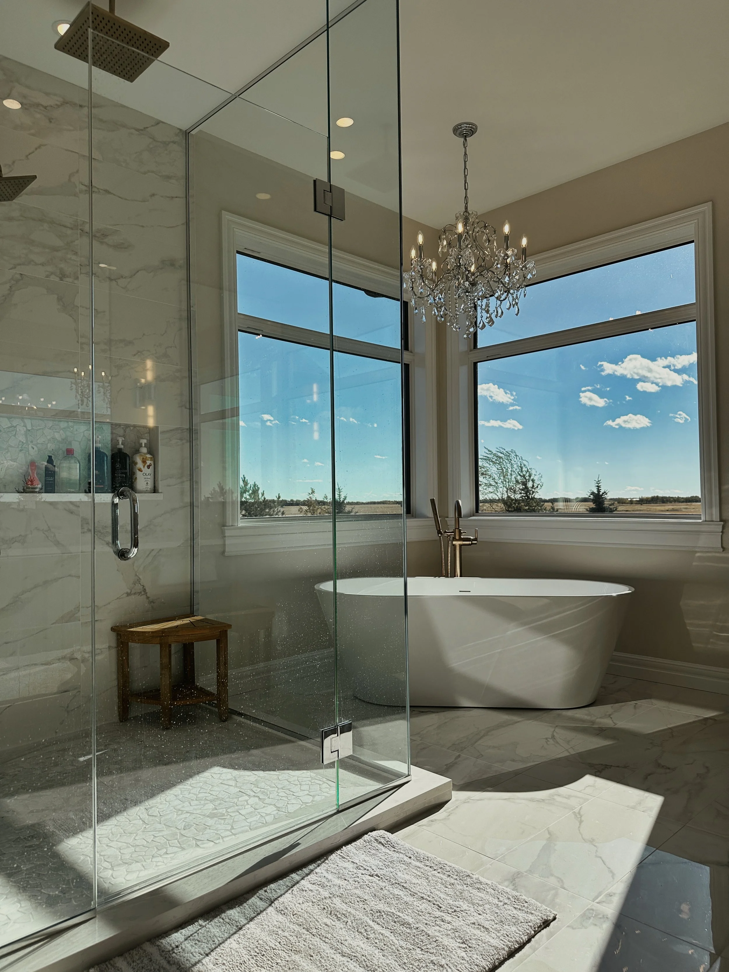 An Ensuite bathroom with free standing tub and glass shower