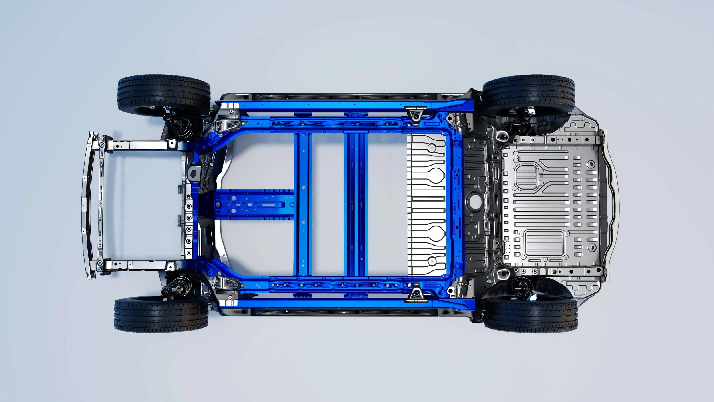 Vista desde arriba de un chasis de coche electrónico con estructura metálica y neumáticos.