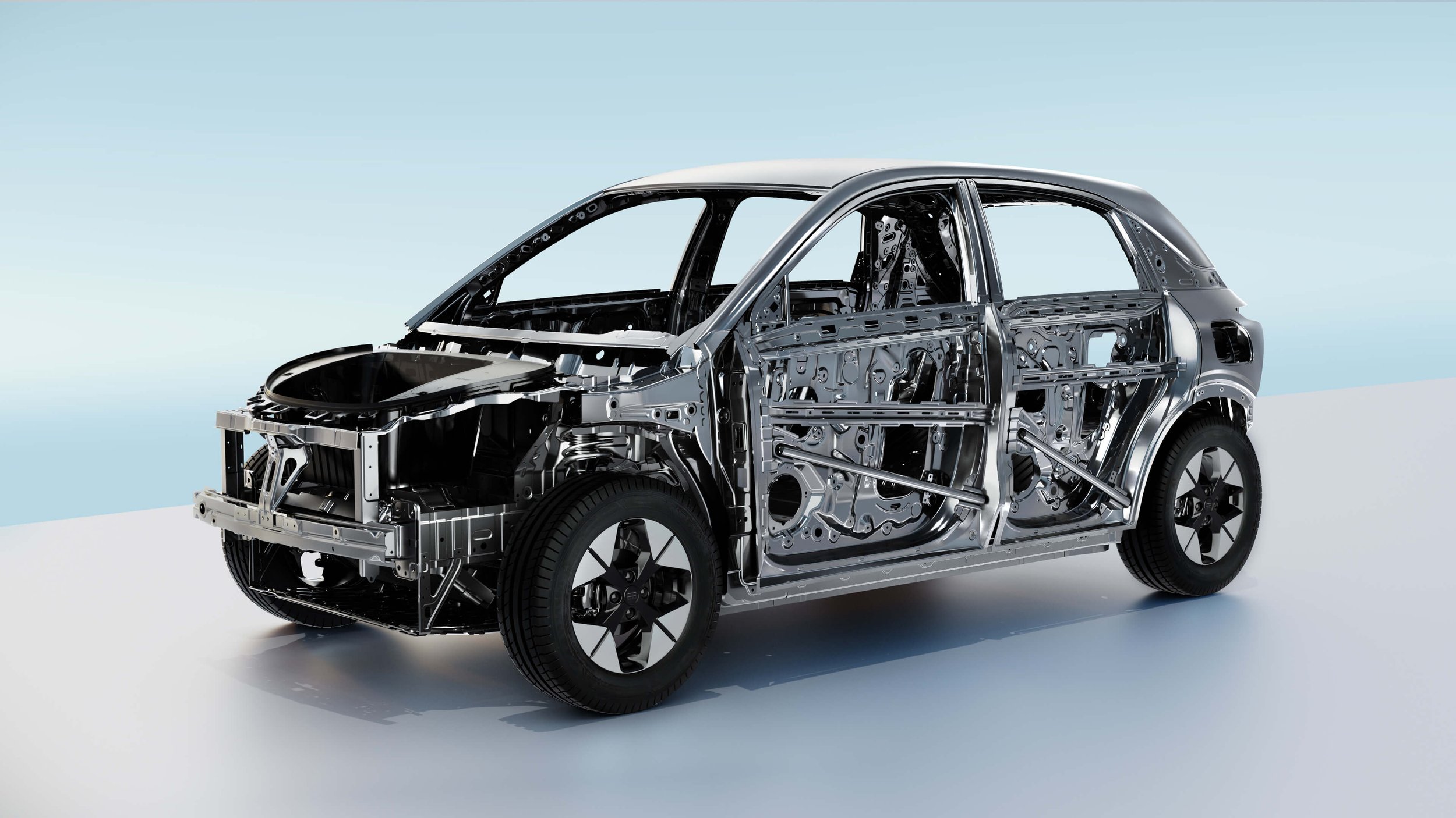 Cuerpo del automóvil en estructura metálica, sin partes de carrocería, mostrando el chasis y componentes internos.