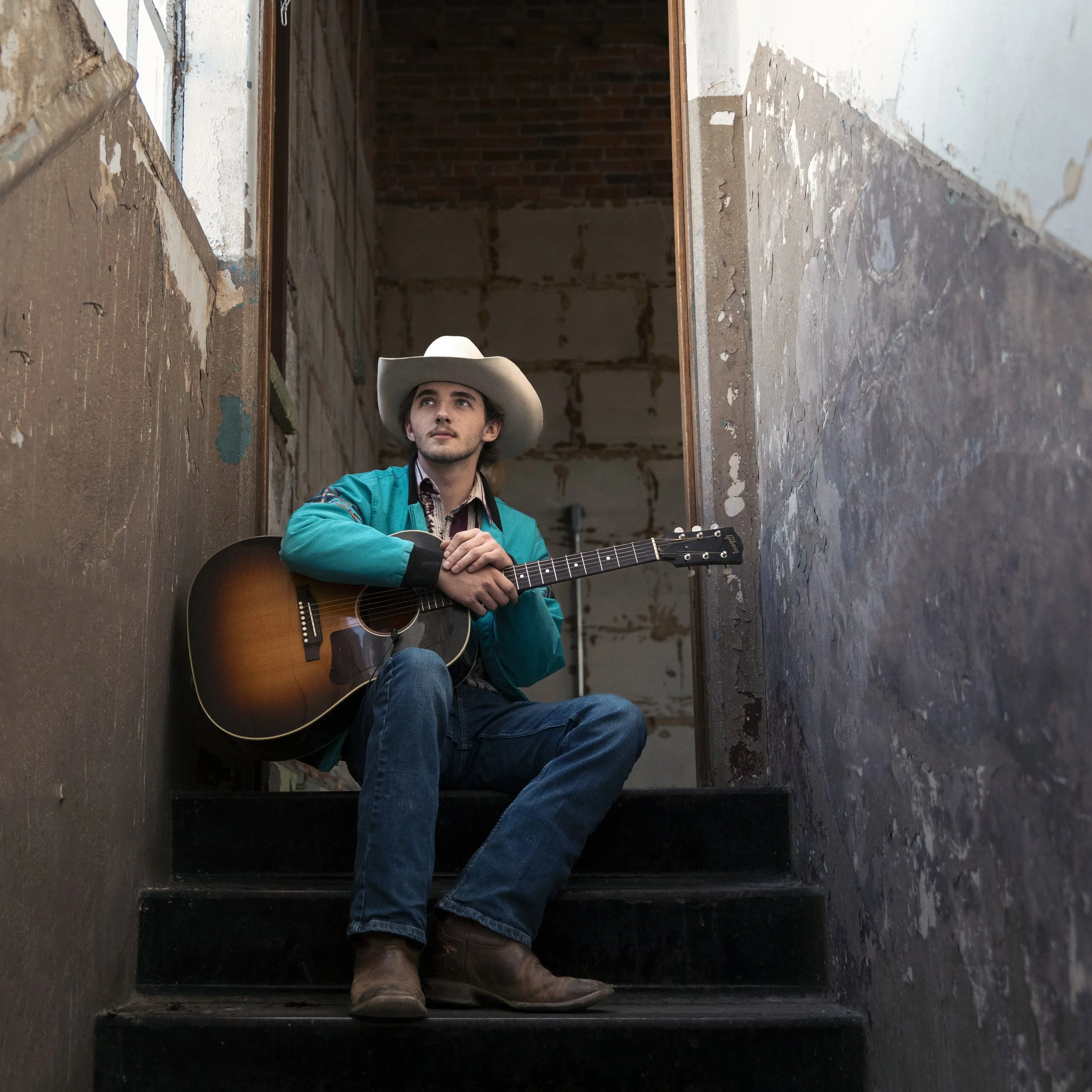 A photograph of Country music artist Kade Hoffman in a stairwell.