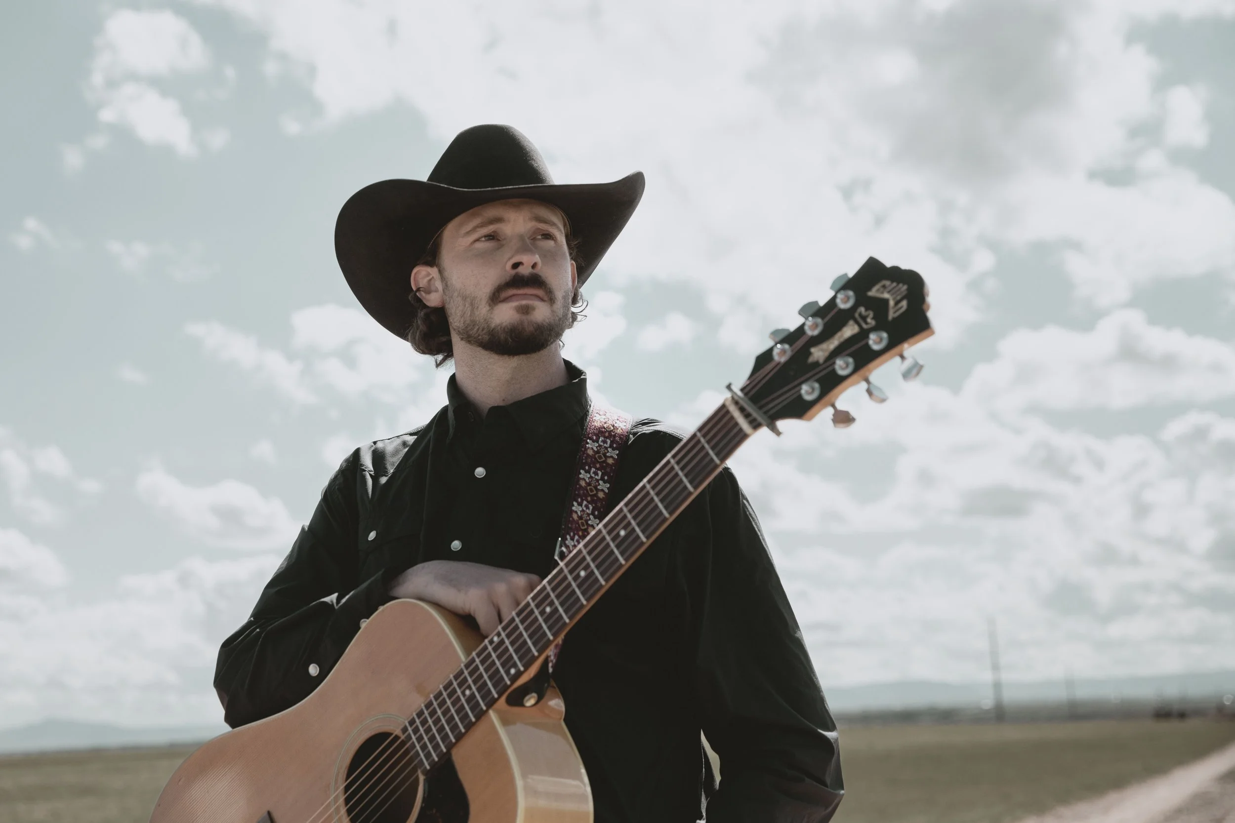 Upcoming country artist Hayden Redwine photographed on the dry prairie.