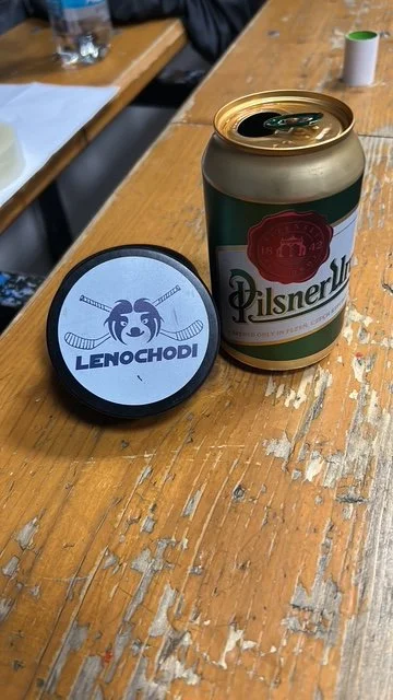 A puck and a can of Pilsner on a pub table