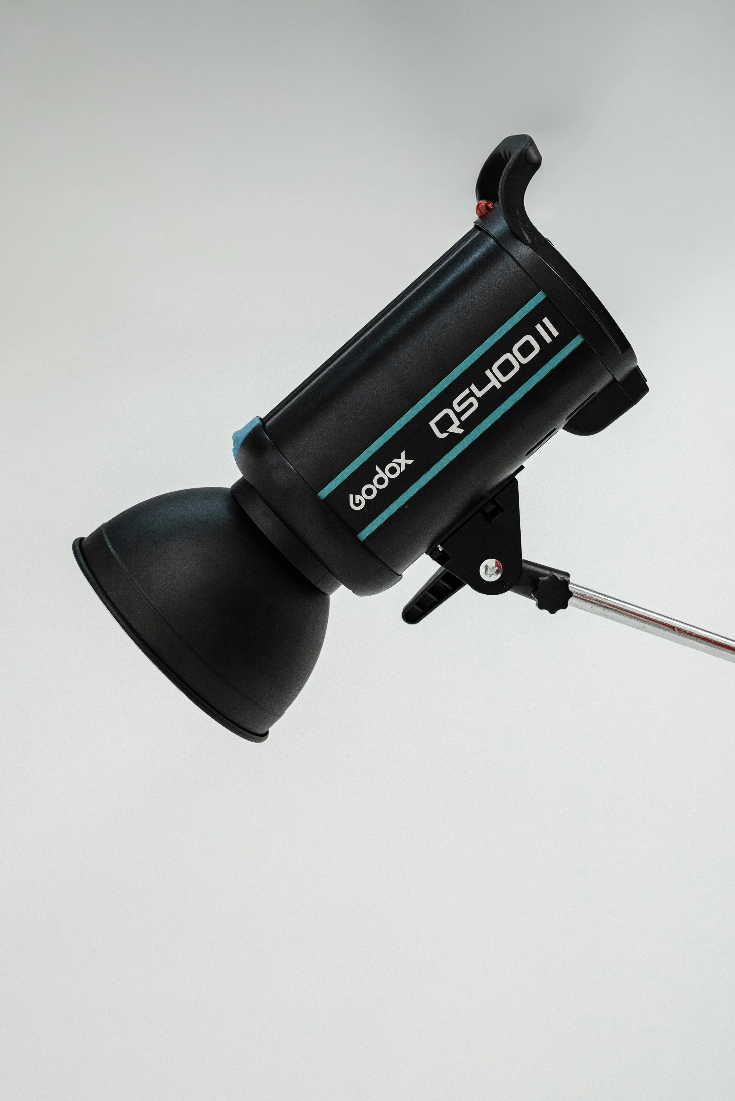 A Godox RS-1000II studio strobe light with a black reflector, mounted on an adjustable metal stand against a plain white background.