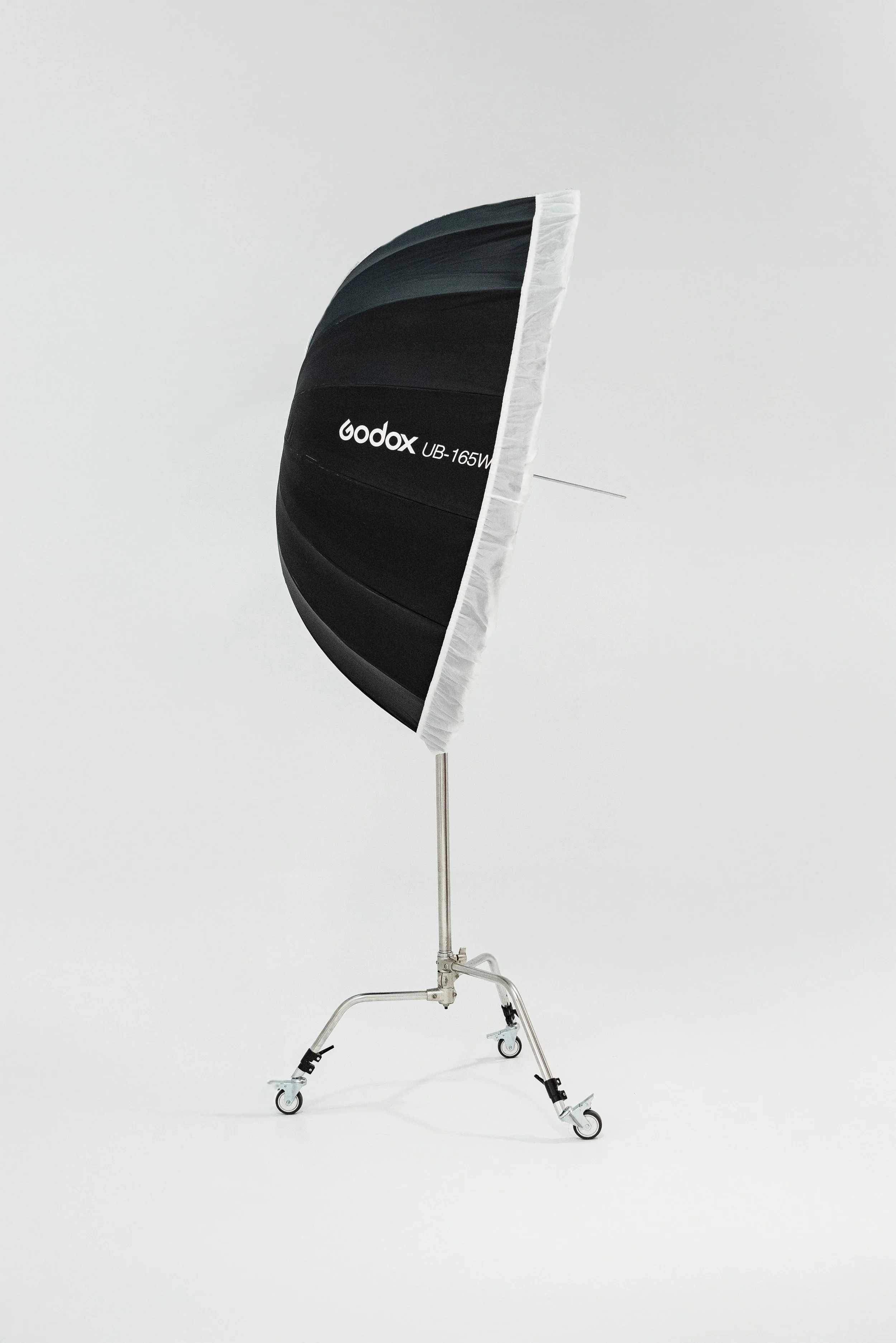 Studio flash softbox attached to a metal stand on wheels, set against a plain white background.