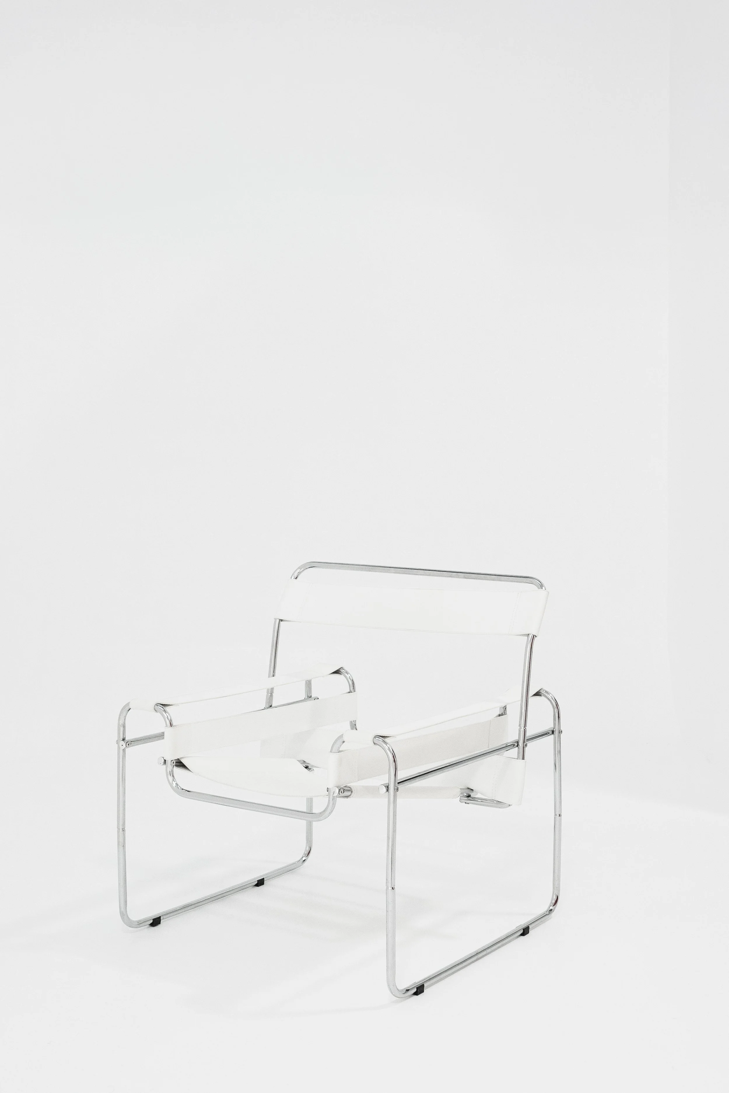 A white lounge chair with metal frame on a plain white background.