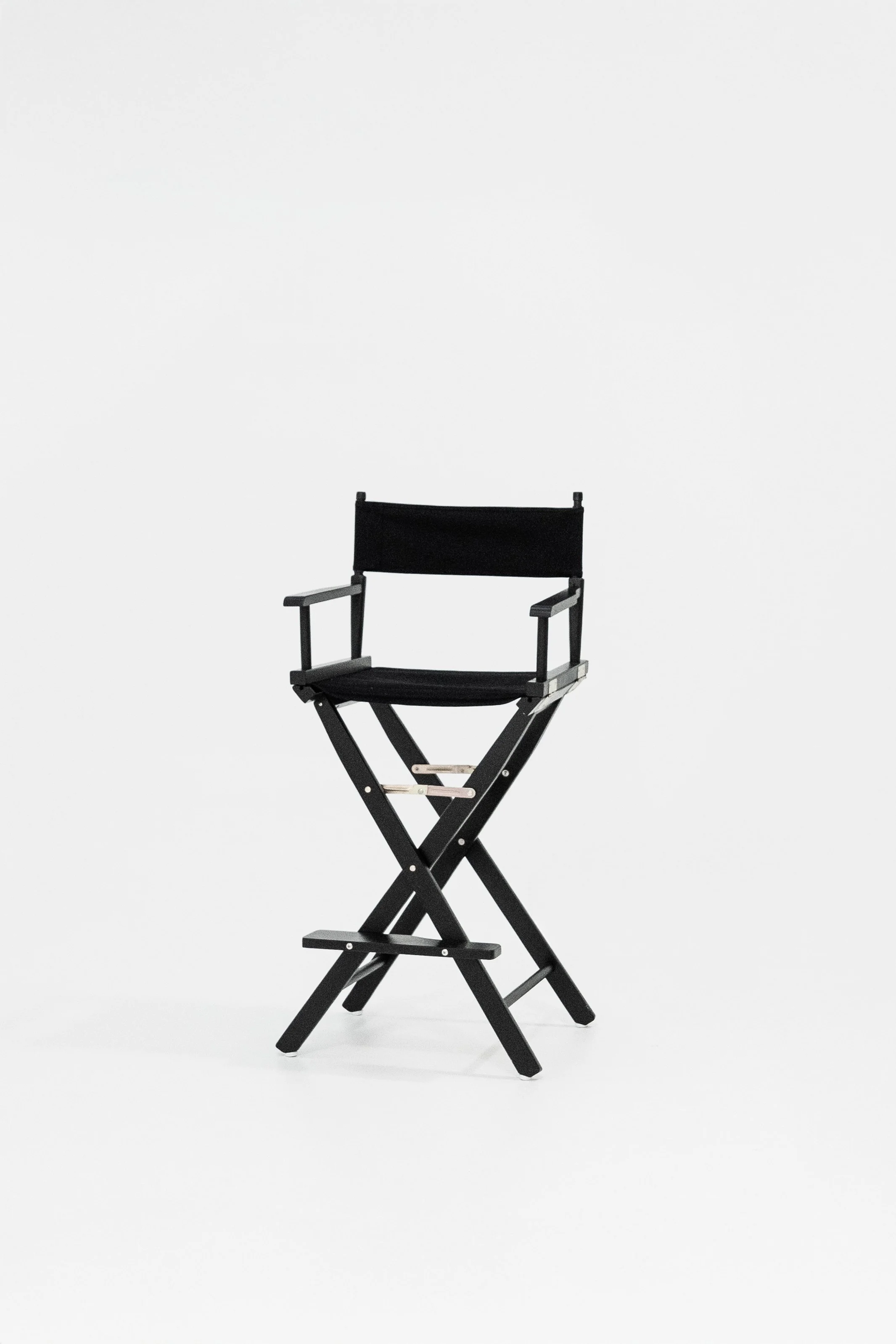 A black director's chair with a fabric seat and backrest on a white background.