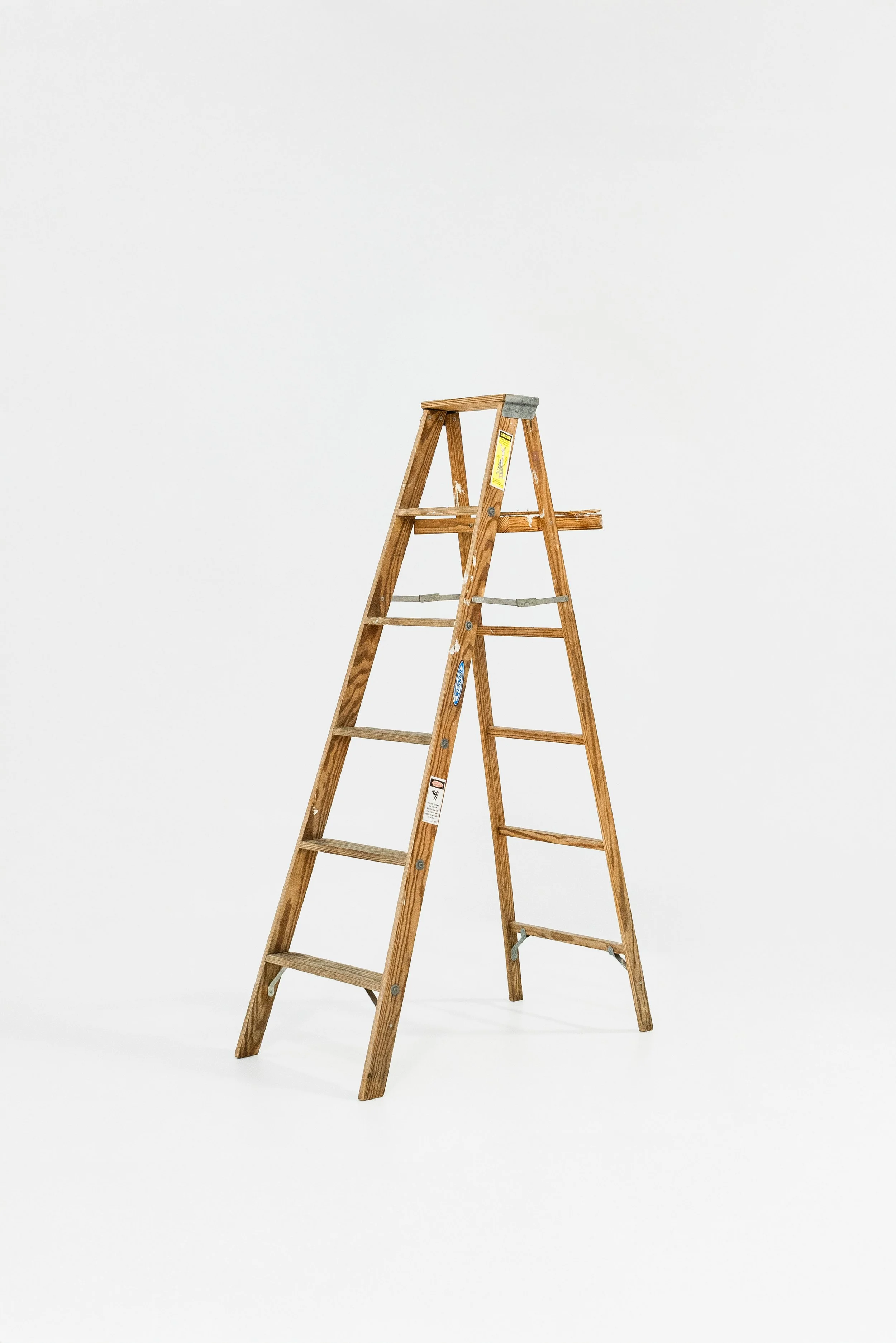 A wooden step ladder with multiple steps, set against a plain white background.