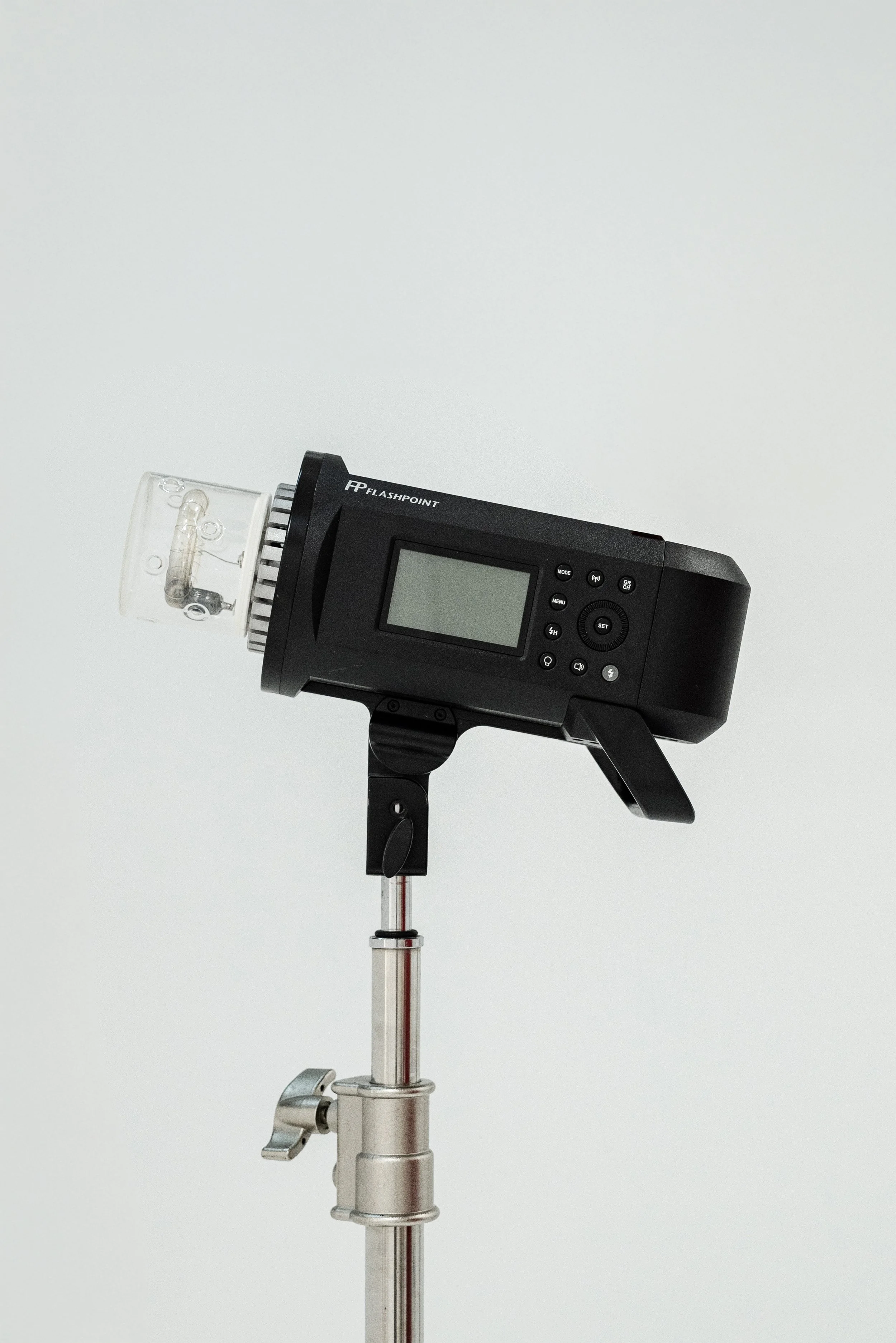 A Flashpoint strobe light on a stand against a white background.