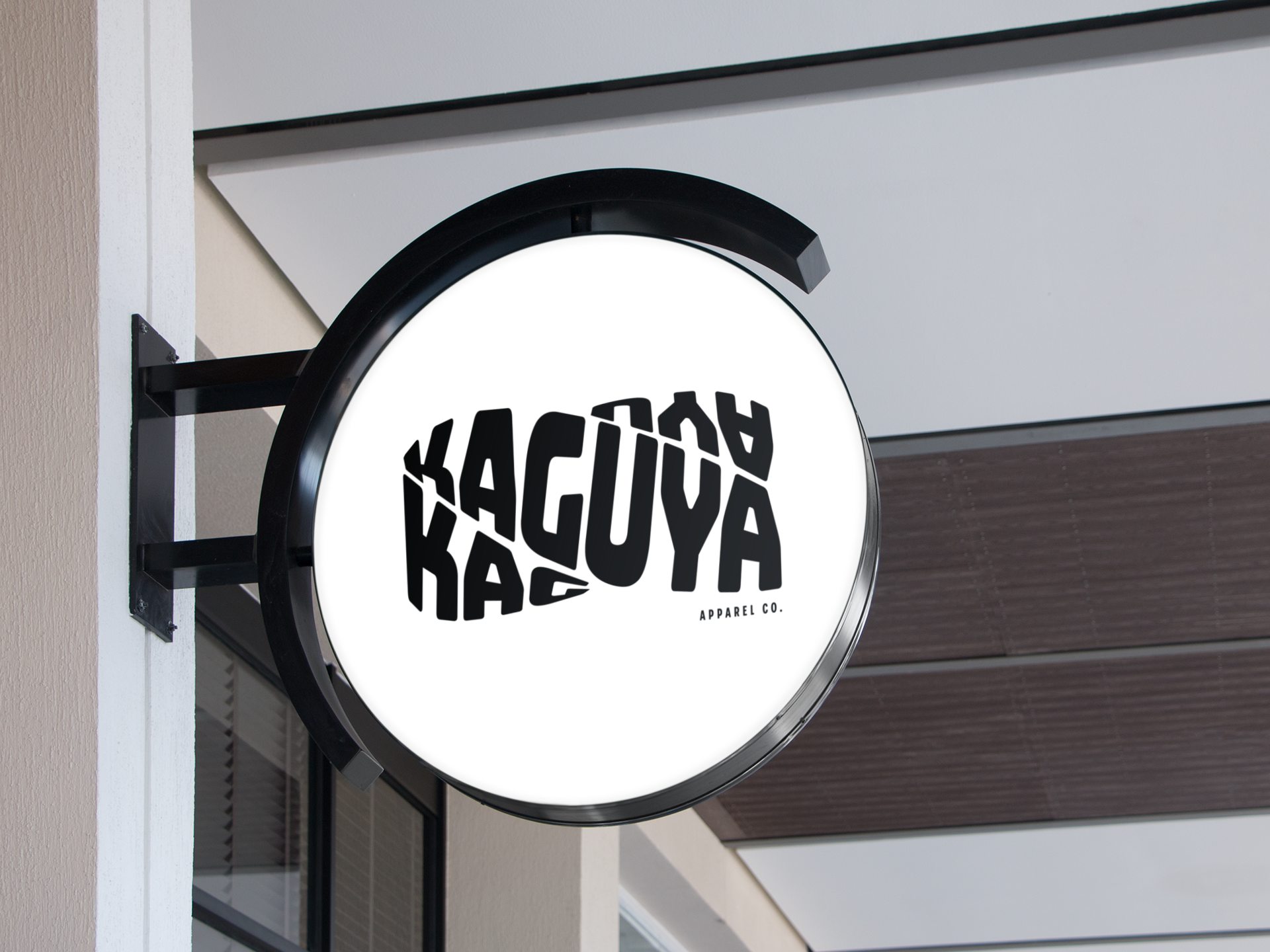 Round illuminated sign for 'Aguya Katsu' apparel store with black text on a white background.