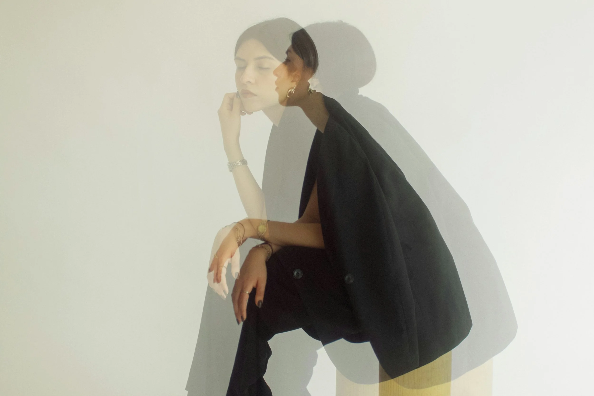 Woman double exposed in black blazer