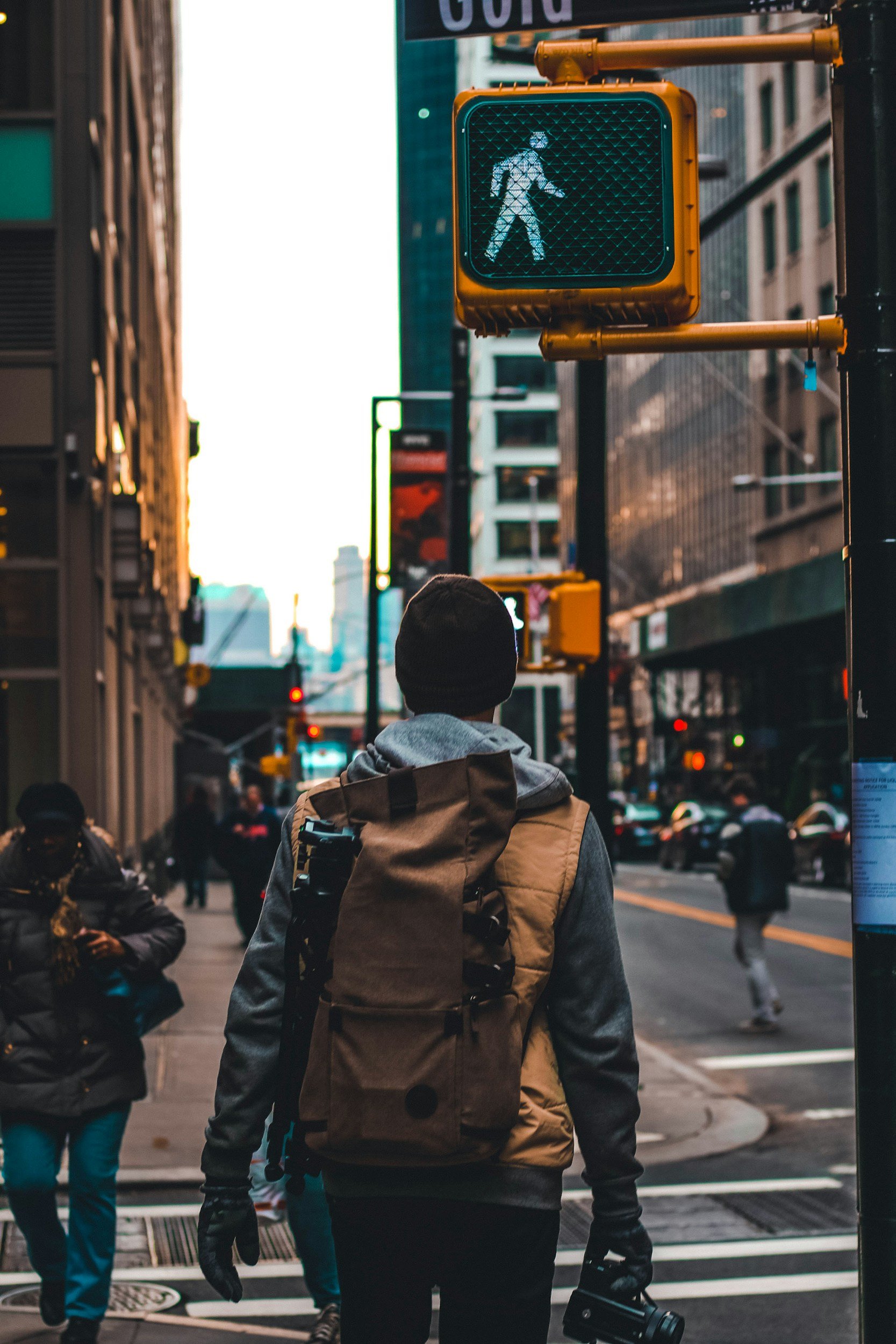 Person walking under walk sign