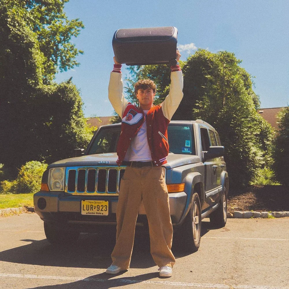 Tanner Grigoli holding a boombox over his head for "Love You Right" song artwork