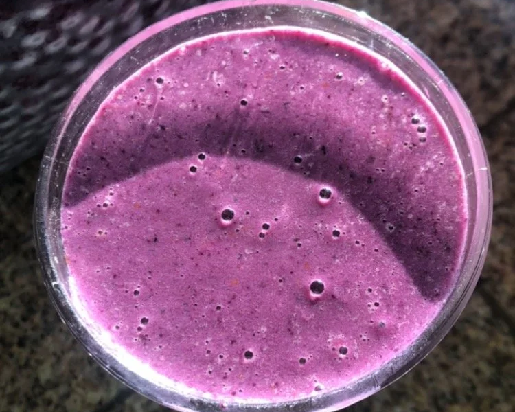 Top view of a purple smoothie in a clear glass