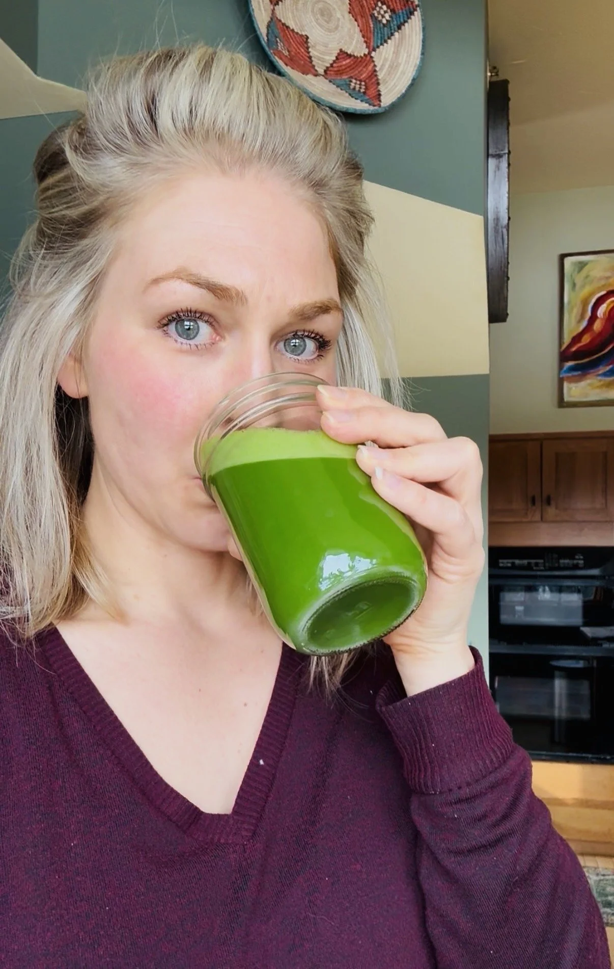 Woman drinking green juice