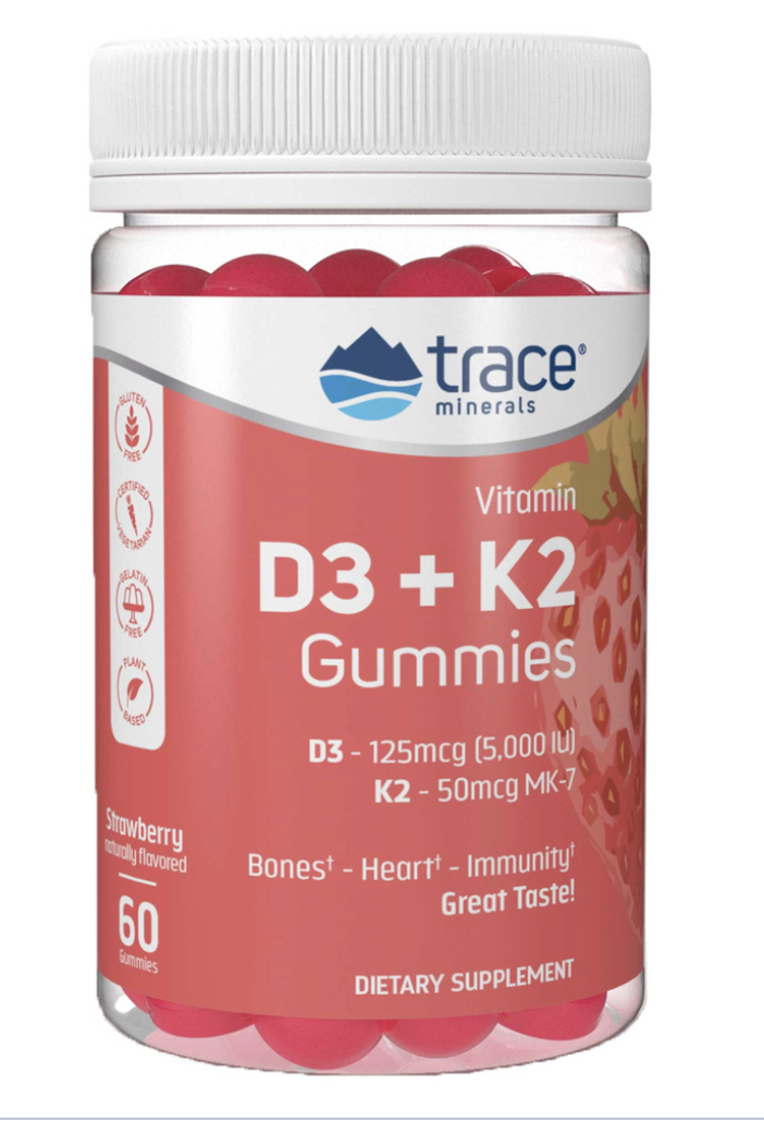 Container of Trace Minerals vitamin D3 and K2 gummies with a white lid, showing strawberry-flavored gummies inside.