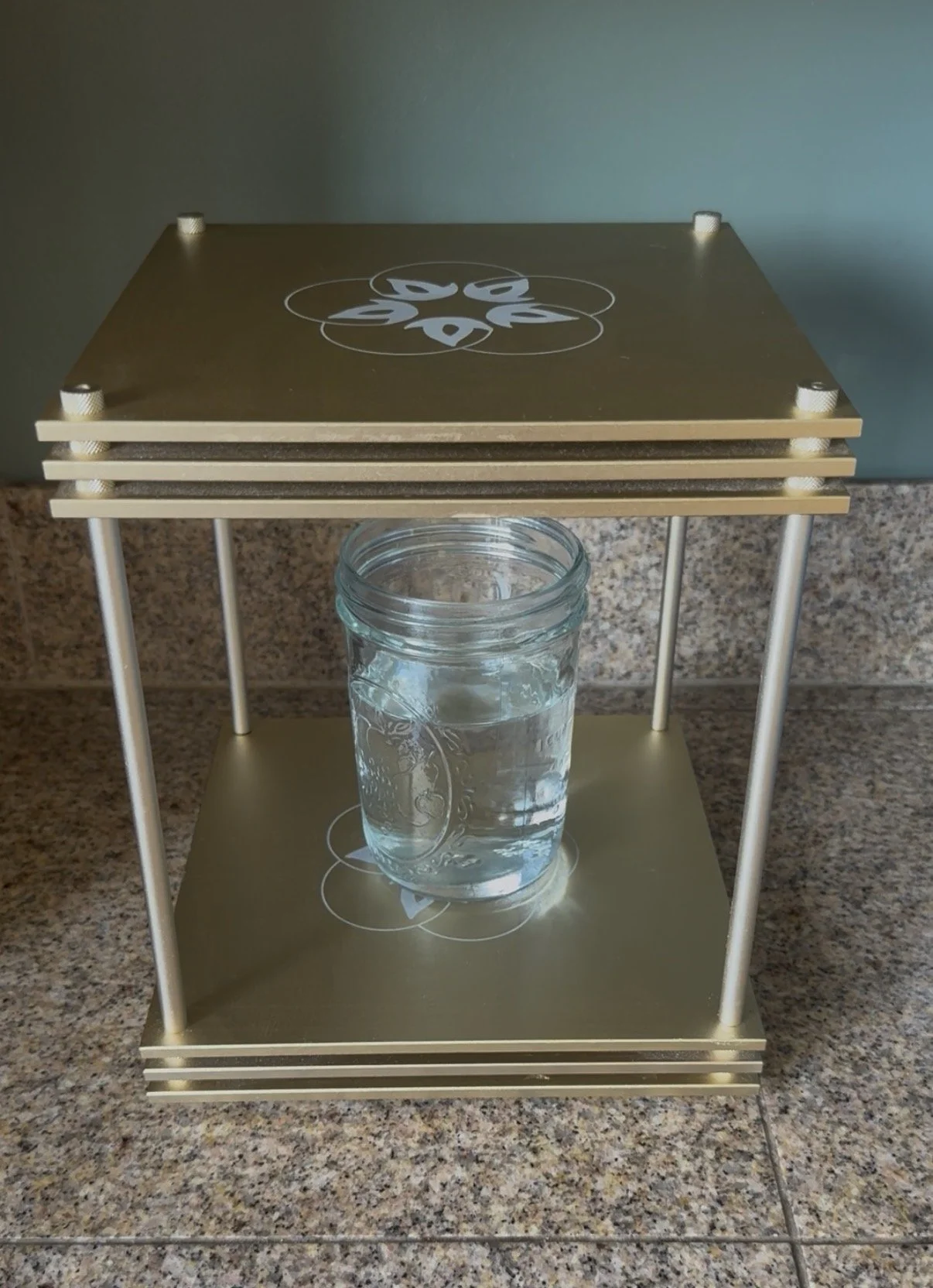 infinity bloc from Leela quantum tea - inside the bronze block is a glass of water
