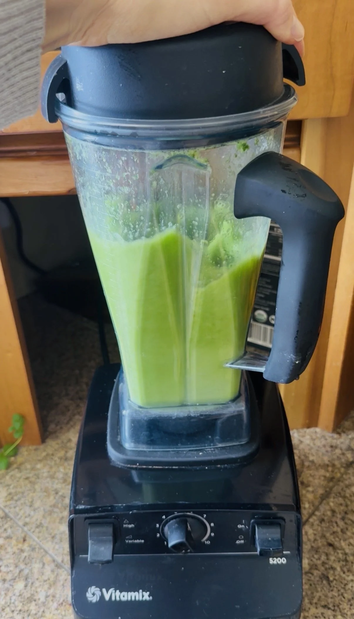 blender mixing green juice on counter