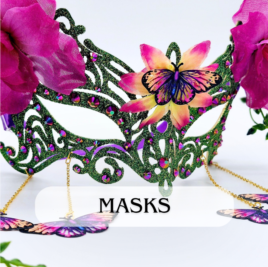 A decorative masquerade mask with purple glitter and floral and butterfly embellishments, surrounded by pink flowers and butterfly accessories, with the word "MASKS" displayed at the bottom.
