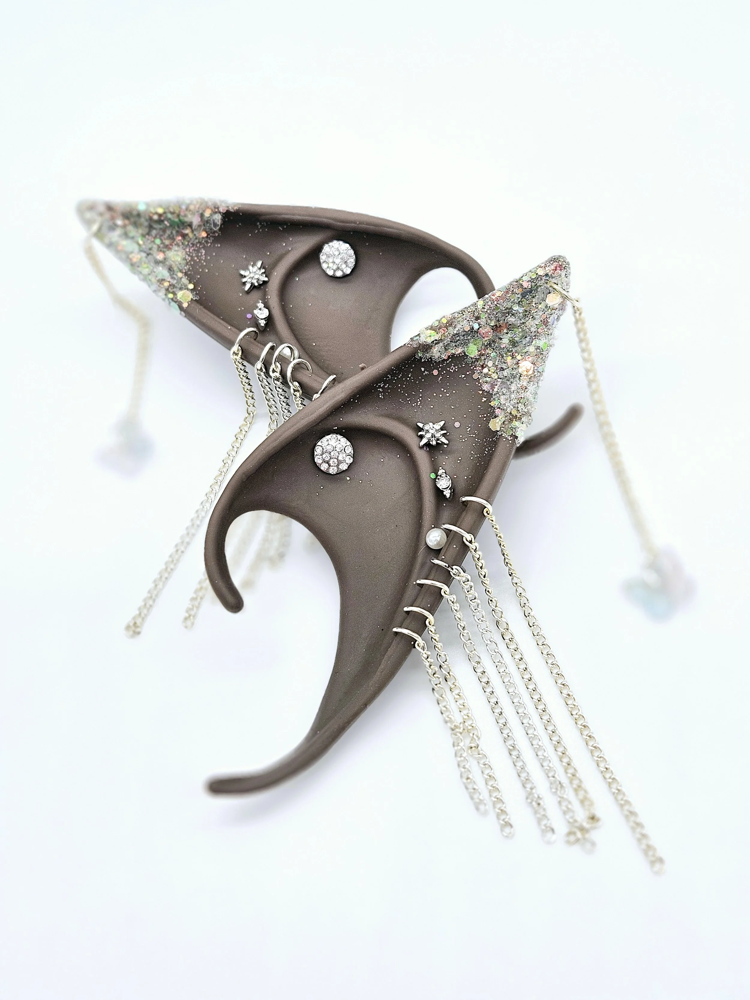 Decorative hair clip with glitter and rhinestone accents on a white background.