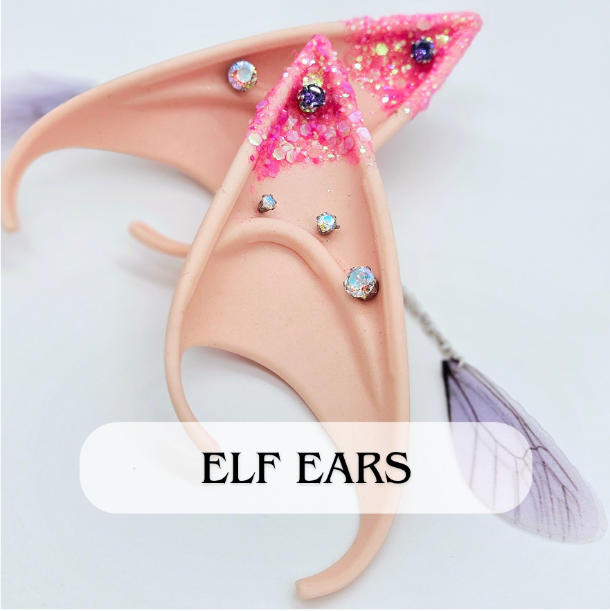 Pink elf ears with glitter and rhinestones, accompanied by fairy wings.