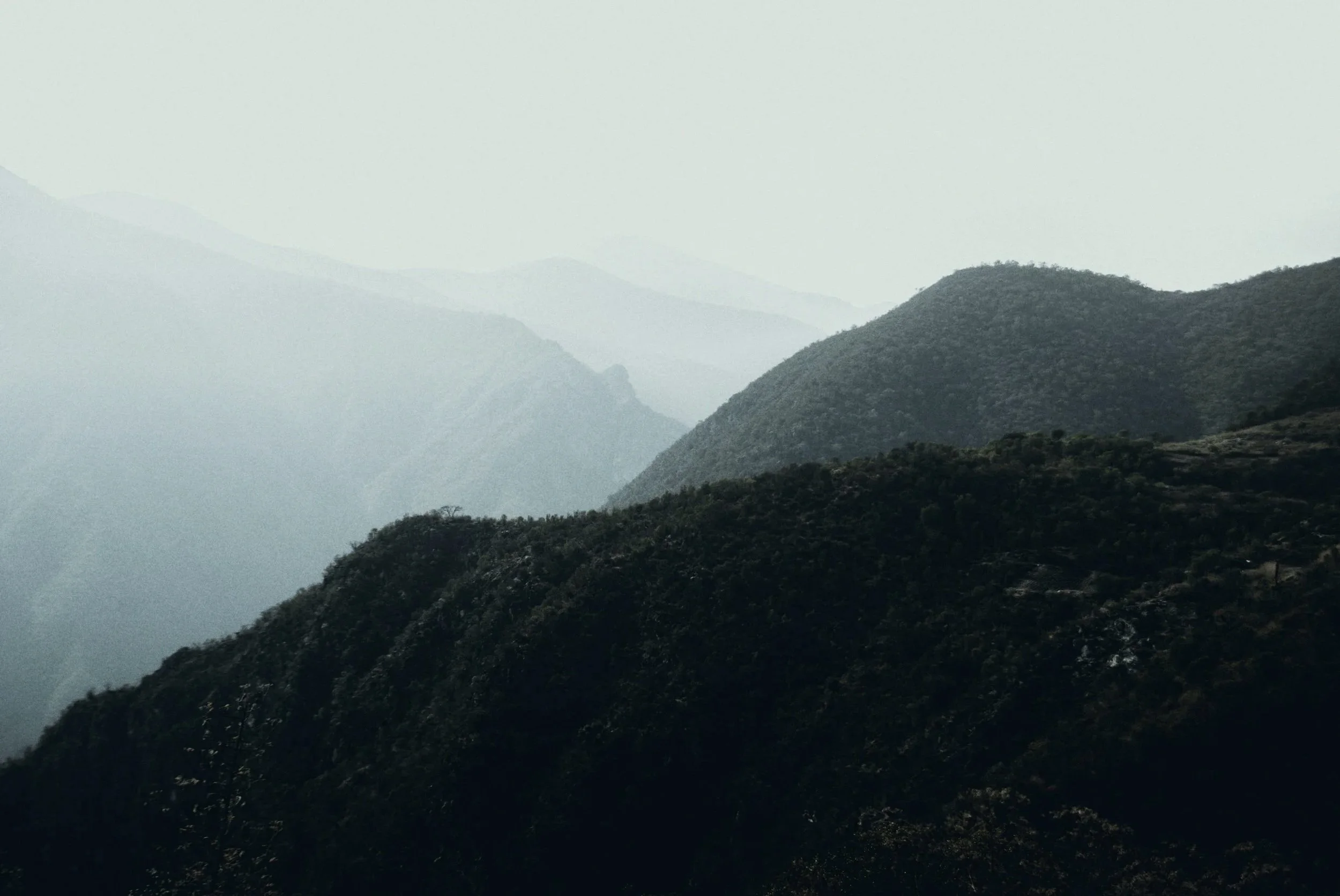 Mountains with layered ridges under a hazy sky