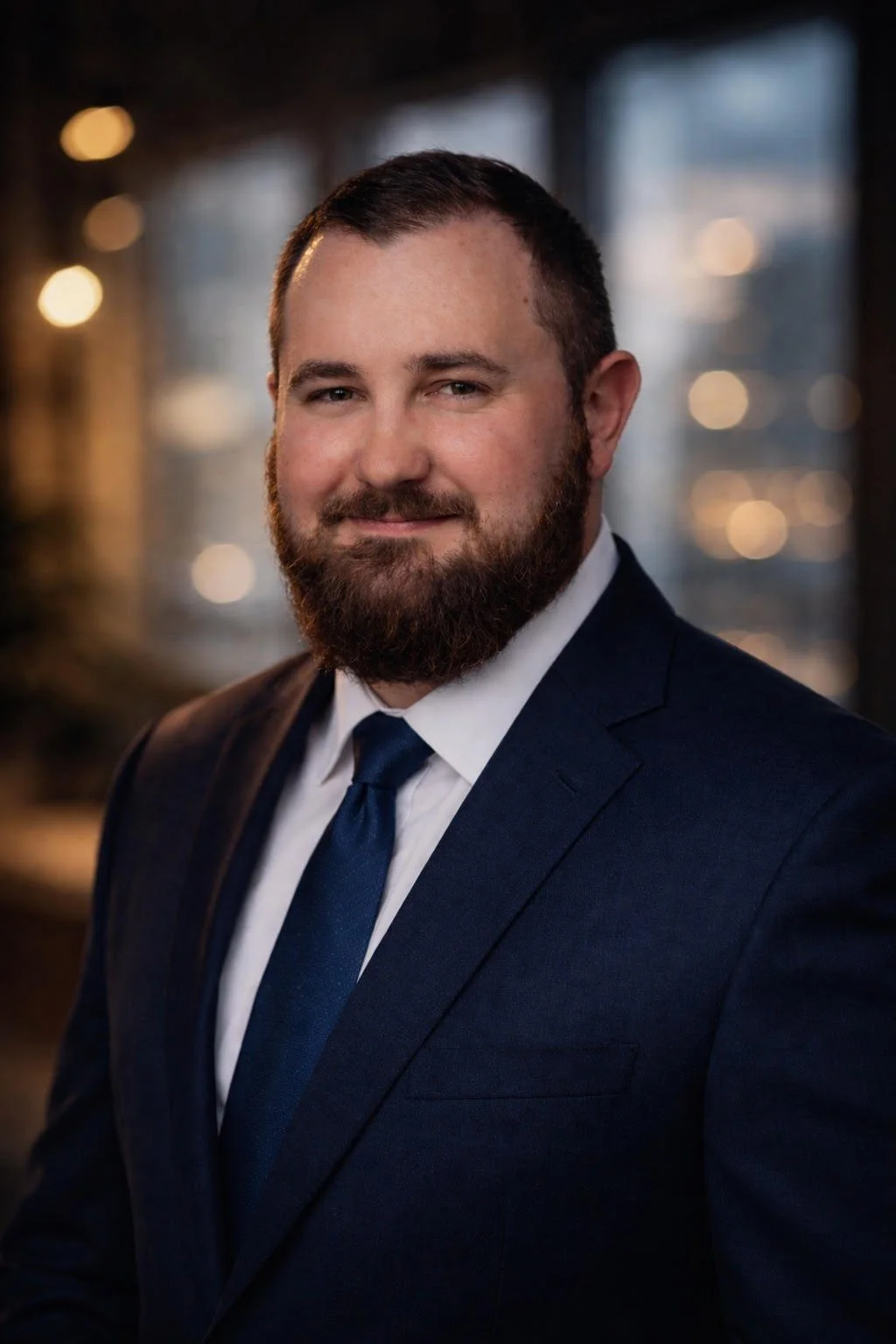 A picture of Justin in a blue suit and blue tie