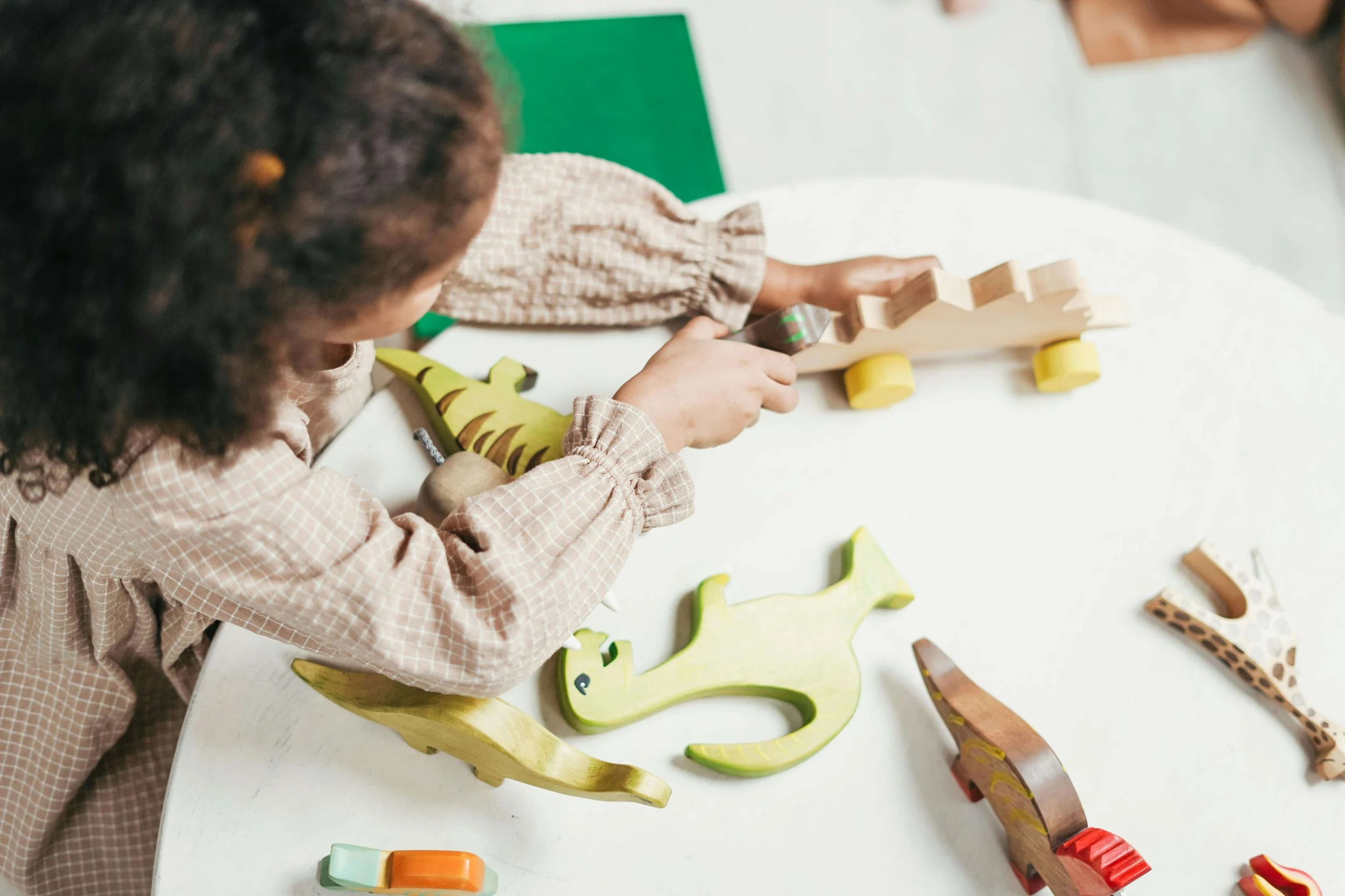 Young girl playing with wooden toys