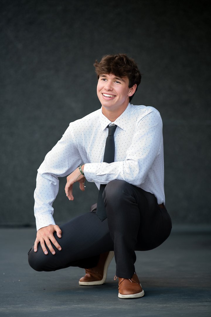 grand-rapids-senior-portrait-dress-shirt-tie-crouching.jpg