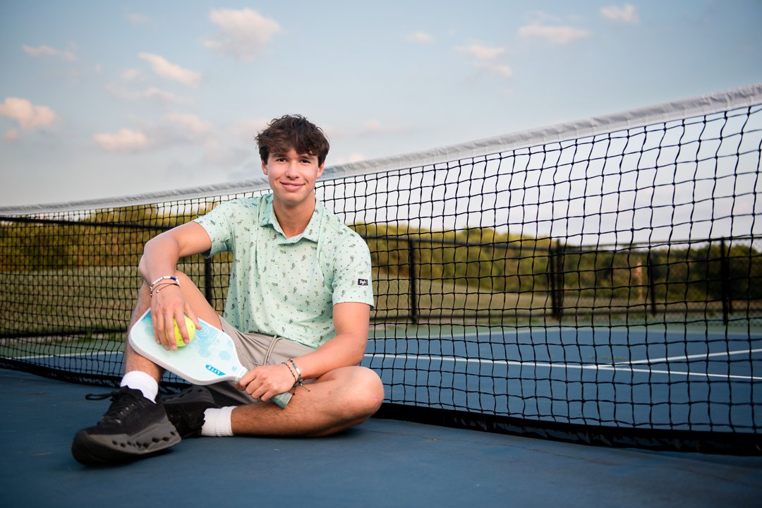 grand-rapids-senior-portrait-pickleball-net-sitting.jpg