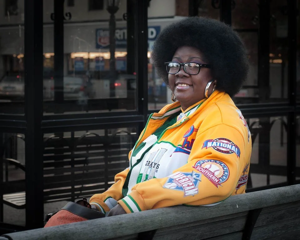 [4/100] Mary - I noticed Mary as I was pulling out of the grocery store. The bright colors of her clothing stood out from the general grayness of the surroundings and, of course, her hair is fantastic! I quickly found a parking spot and walked back t