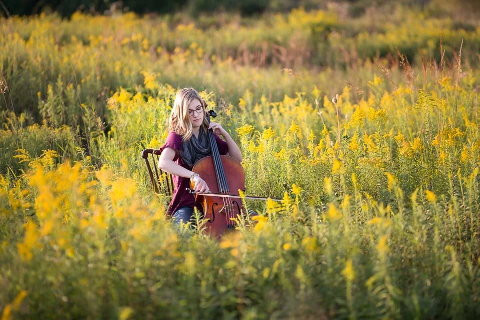 grand-rapids-senior-portrait-of-girl-playing-cello-in-fall-field.jpg
